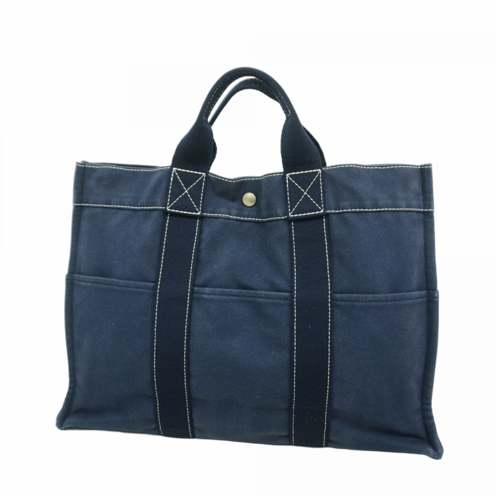 Canvas tote bag by Hermes: Canvas tote bag by Hermes Canvas tote bag by Hermes, featuring navy canvas and silver hardware. This used tote bag shows signs of previous use, with traces of scratches and dirt, but remains in good c