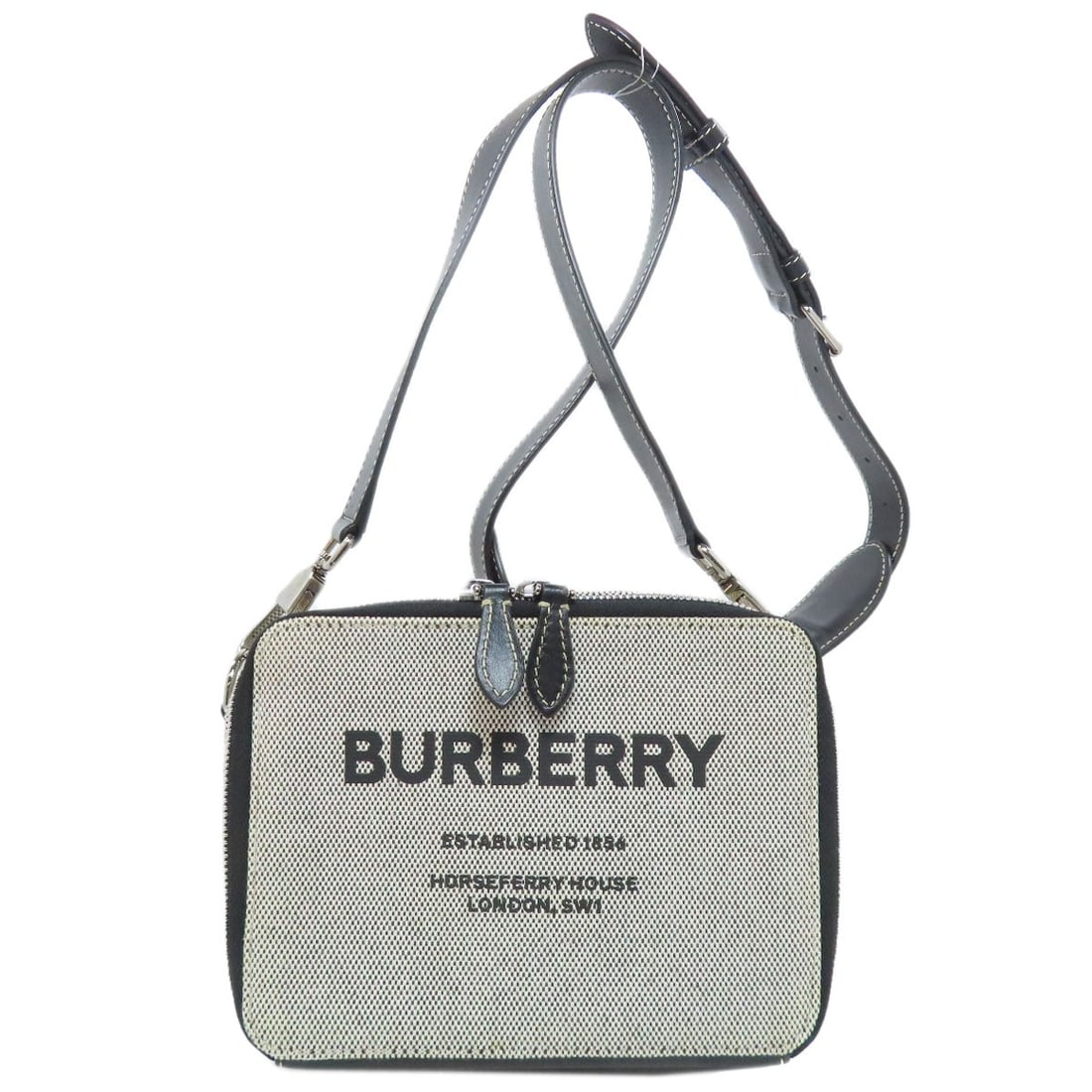 Canvas bag logo by Burberry shoulder: Canvas bag logo by Burberry shoulder Gray canvas bag with Burberry logo on the shoulder. This shoulder bag features a notable Burberry logo, making it a distinctive accessory for those who appreciate 