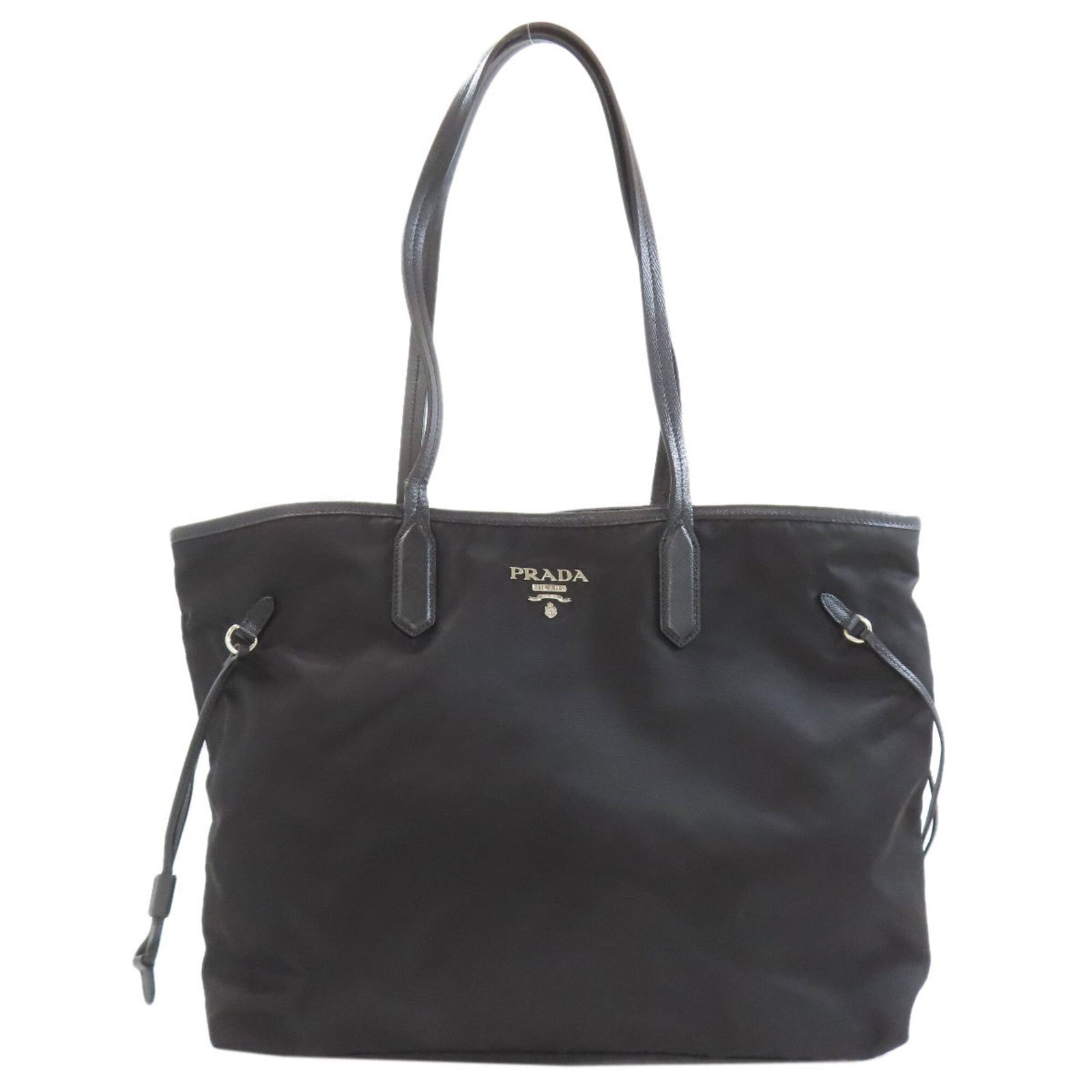 Tote Bag Nylon by Prada: Tote Bag Nylon by Prada Black Prada Tote Bag made from high-quality Nylon, with a classic design and timeless style. The bag has some minor scratches and dirt, but remains in very good condition
