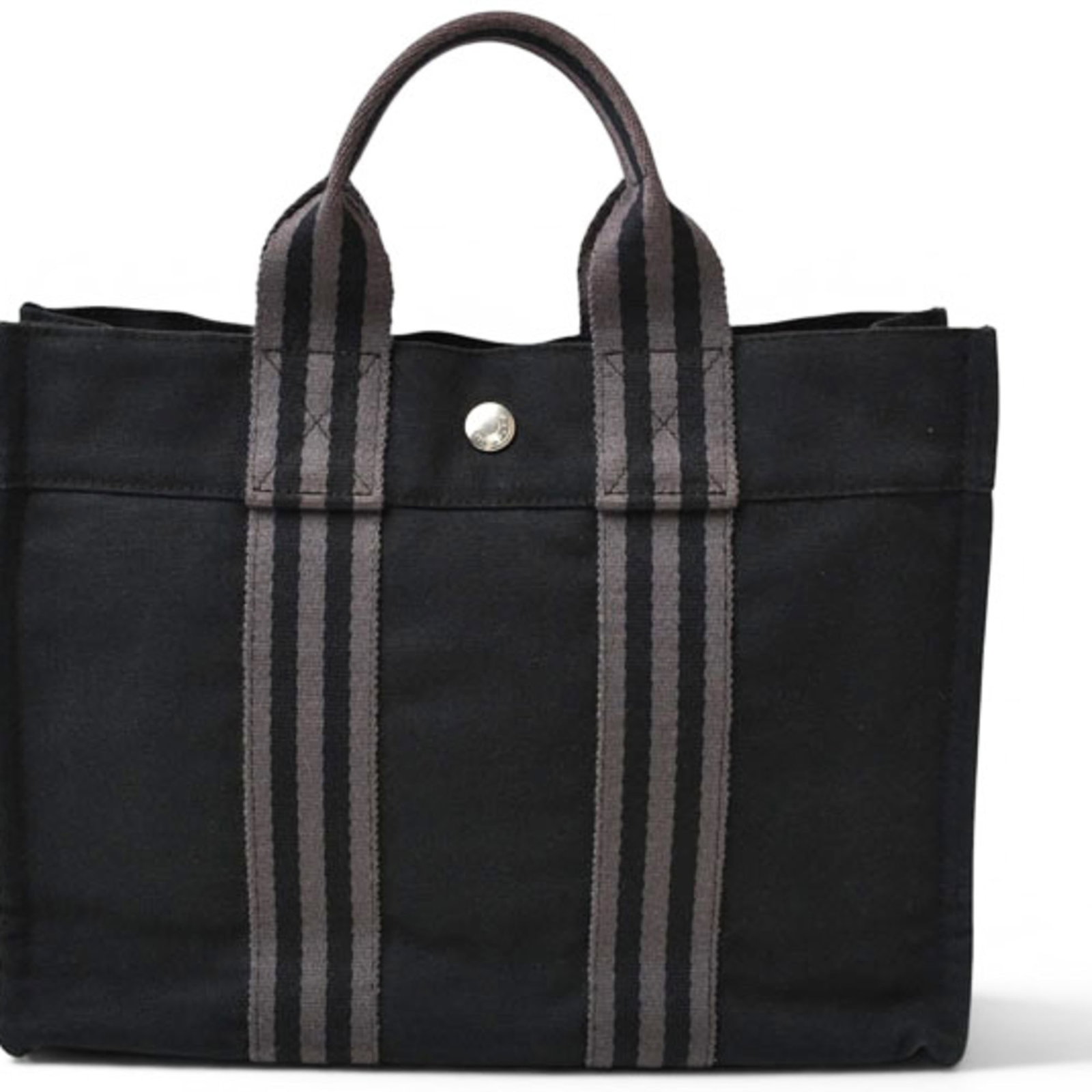 Cotton Hermes Tote Handbag: Cotton Hermes Tote Handbag Black cotton tote bag from Hermes with silver hardware and snap fastener closure, featuring a classic design with a few subtle signs of wear. The bag measures 22.5cm x 30cm
