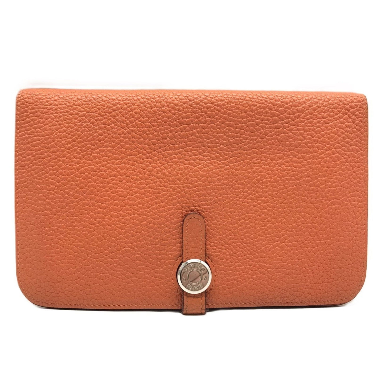 Hermes Pouch Leather Taurillon Clemence: Hermes Pouch Leather Taurillon Clemence Taurillon Clemence leather pouch from Hermes, featuring a vibrant orange color and classic design. This used item shows traces of usage with minor scratches and