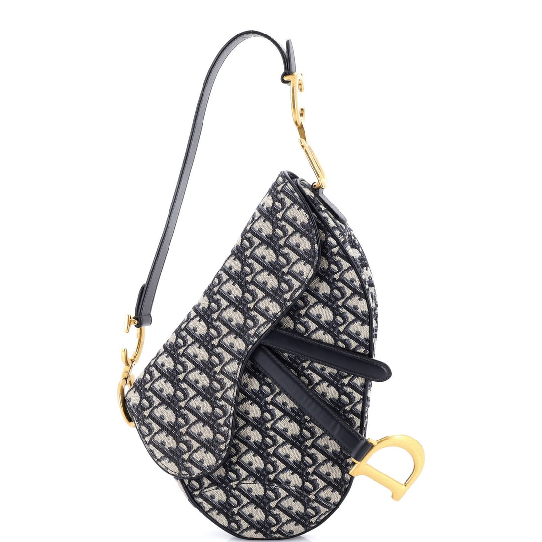 Canvas handbag saddle medium oblique Christian Dior: Canvas handbag saddle medium oblique Christian Dior Canvas handbag saddle medium oblique Christian Dior features a blue canvas exterior with minor scuffs and creases, giving it a worn-in look. The bag