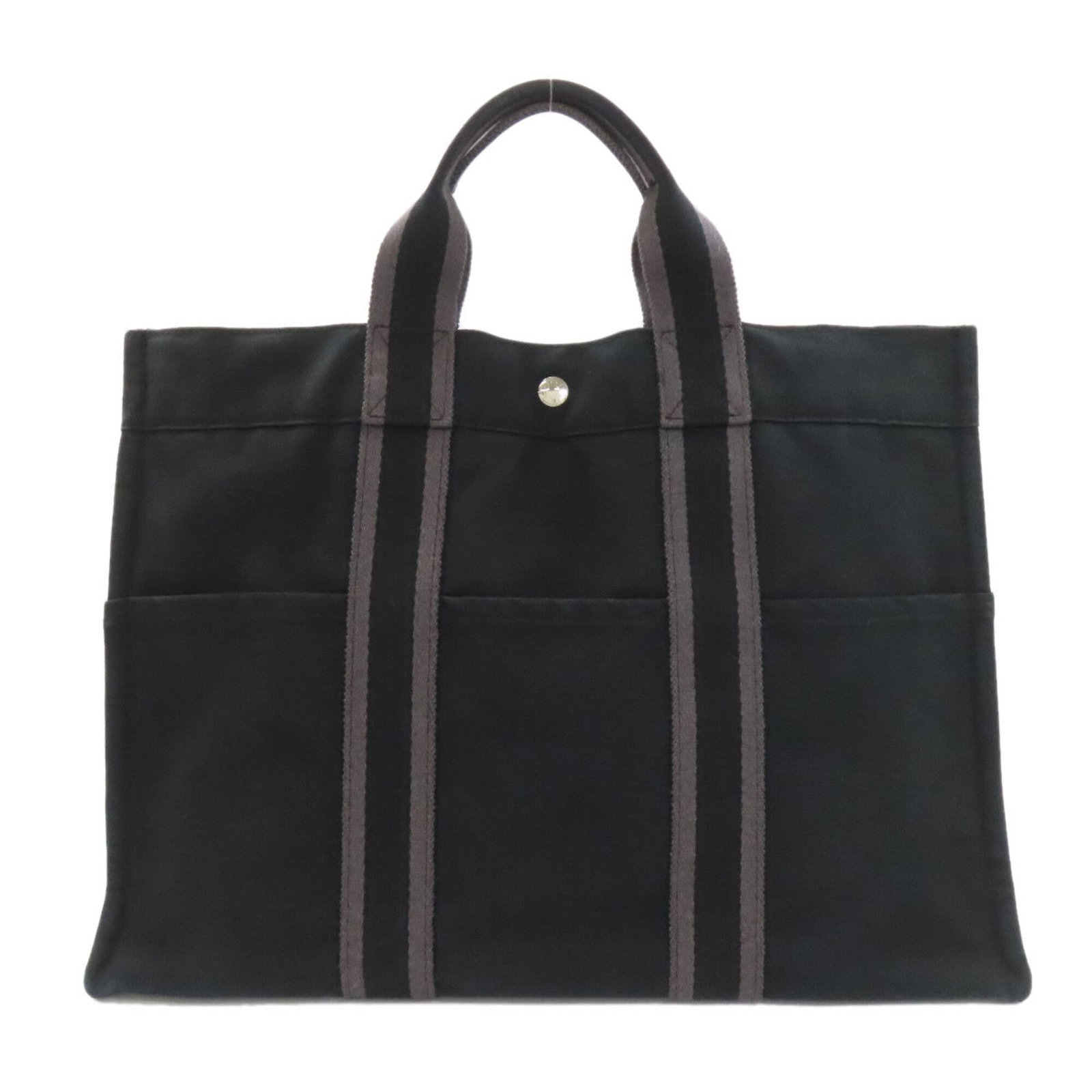 Canvas tote bag by Hermes: Canvas tote bag by Hermes Canvas tote bag by Hermes, featuring a timeless black canvas design with a few traces of usage and minor scratches. The bag's classic size and simple style make it a