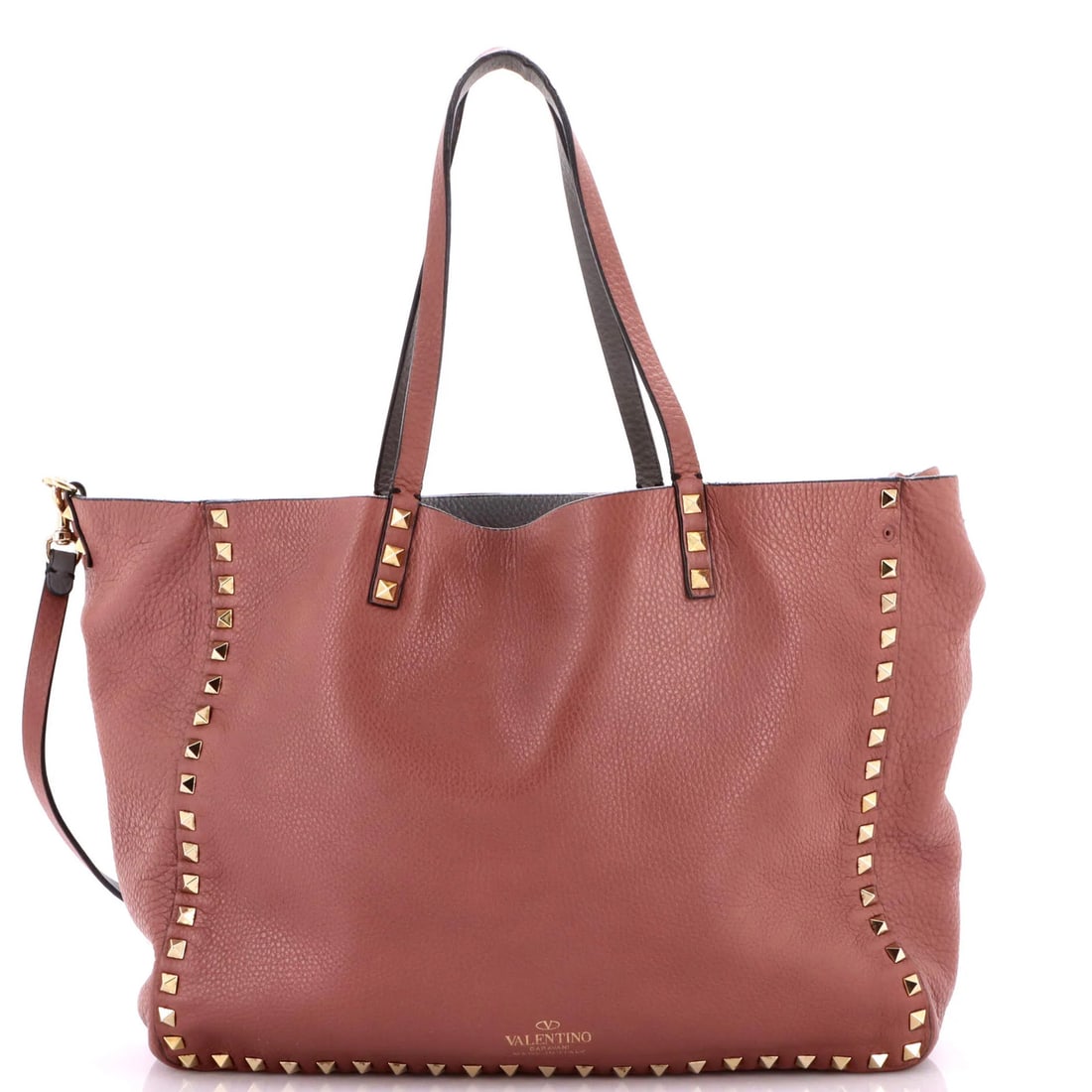 Rockstud reversible medium leather tote by Valentino Garavani: Rockstud reversible medium leather tote by Valentino Garavani Pink Rockstud reversible medium leather tote by Valentino Garavani, featuring a convertible design with gold tone hardware and a spacious 
