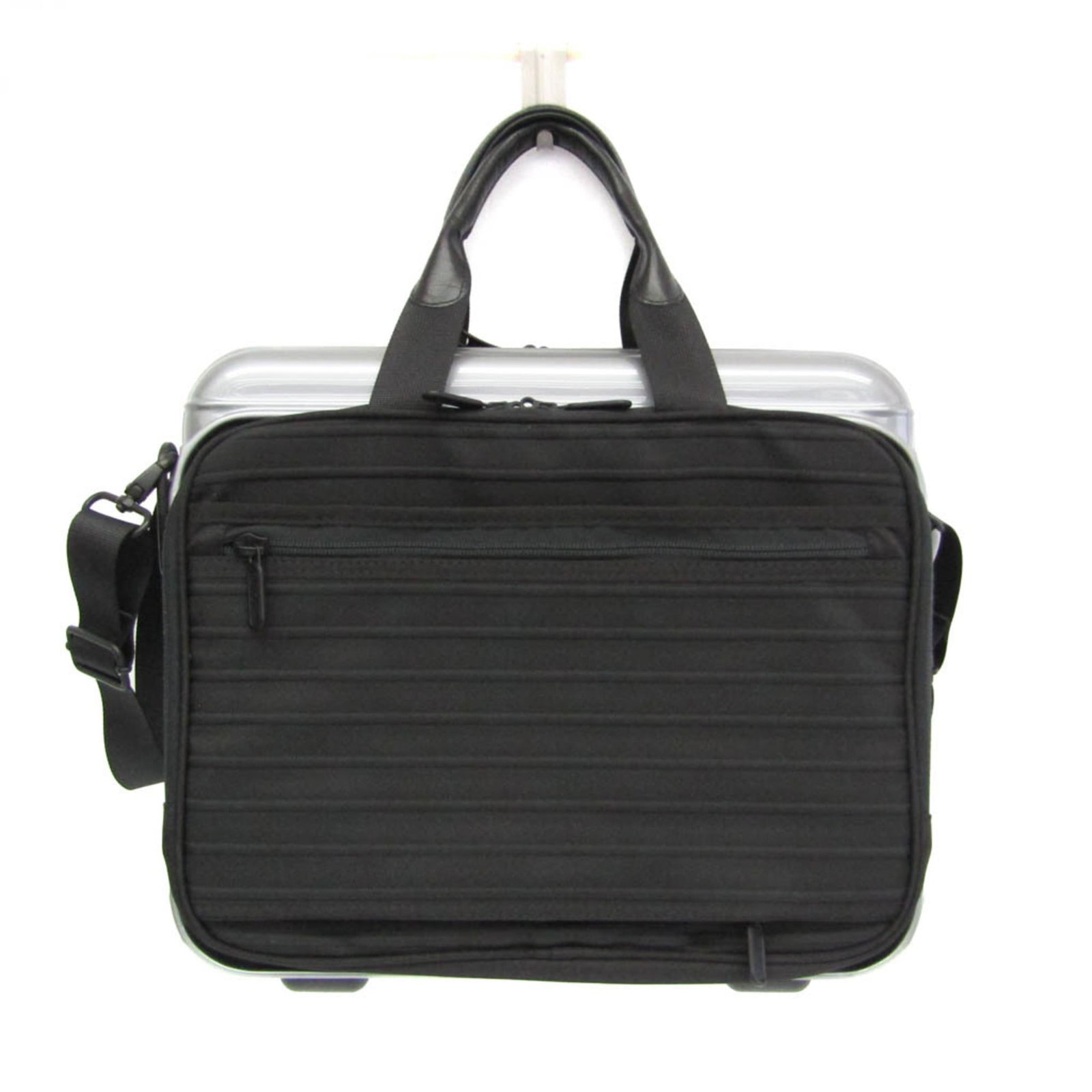 Polycarbonate polyester rimowa attach case: Polycarbonate polyester rimowa attach case The Rimowa Attach Case features a durable polycarbonate and polyester construction, with a sleek black and silver design. A practical combination of open