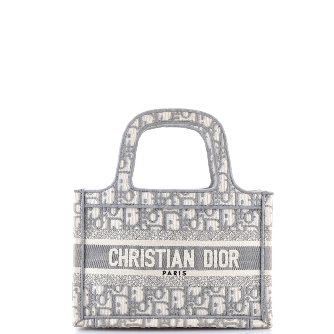 Christian Dior Mini Canvas Tote Book Embroidered: Christian Dior Mini Canvas Tote Book Embroidered Christian Dior's Mini Canvas Tote Book Embroidered boasts a sleek gray exterior and interior, crafted from plain canvas. The compact design features a