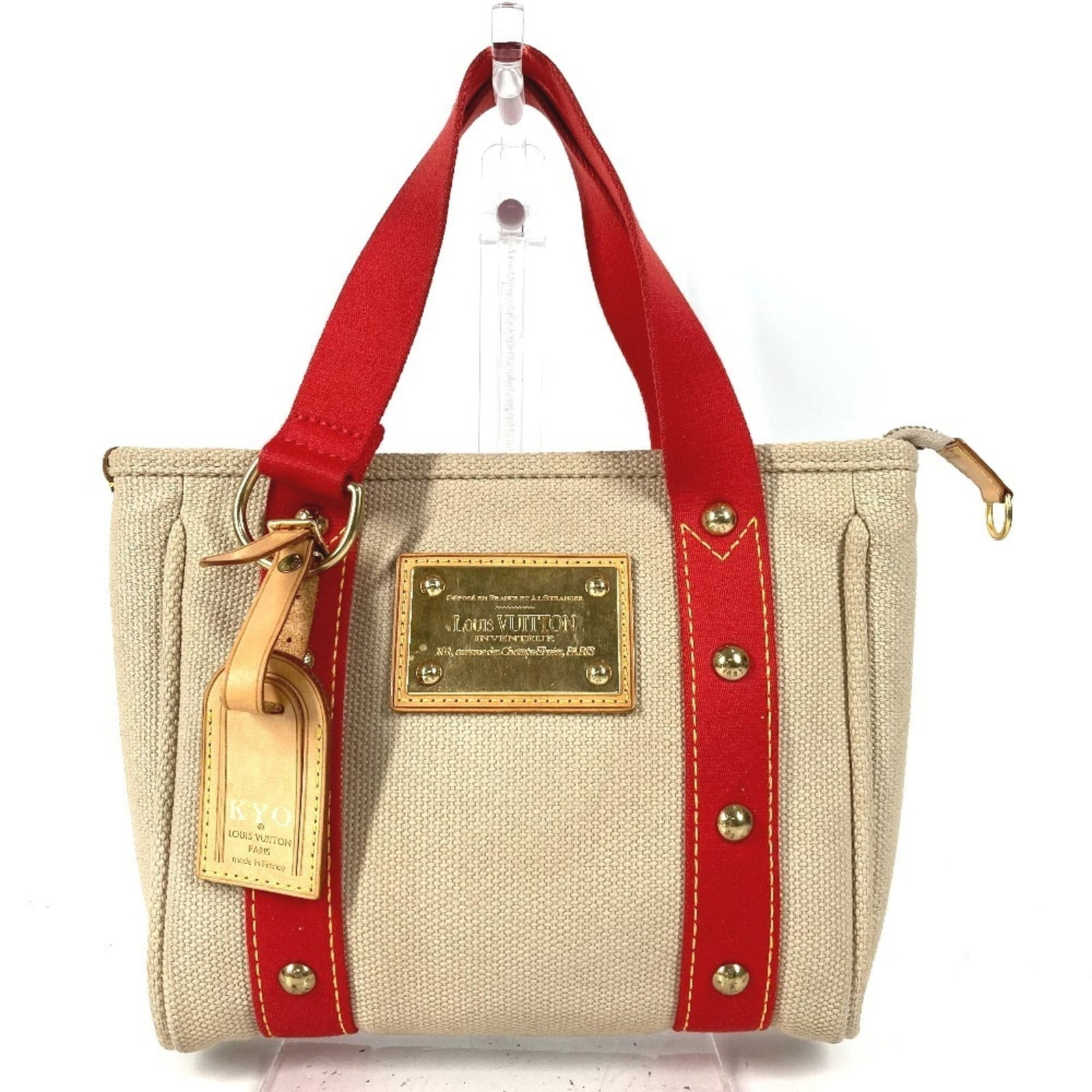 Louis Vuitton Handbag Tote Bag Cotton: Louis Vuitton Handbag Tote Bag Cotton Louis Vuitton Cotton Tote Bag for Women. This beige and red striped tote bag features the iconic Louis Vuitton design, made from high-quality cotton material.
