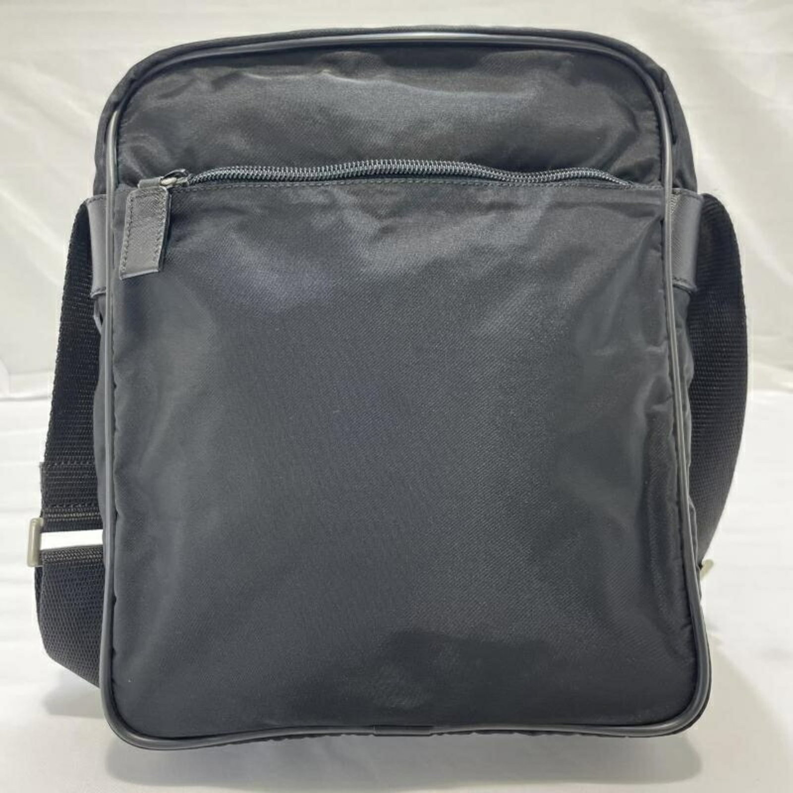 Shoulder Bag Nylon by Prada: Shoulder Bag Nylon by Prada Prada's Nylon shoulder bag boasts a sleek, modern design with clean lines and minimal ornamentation. Made from durable nylon, the bag features a classic black color that