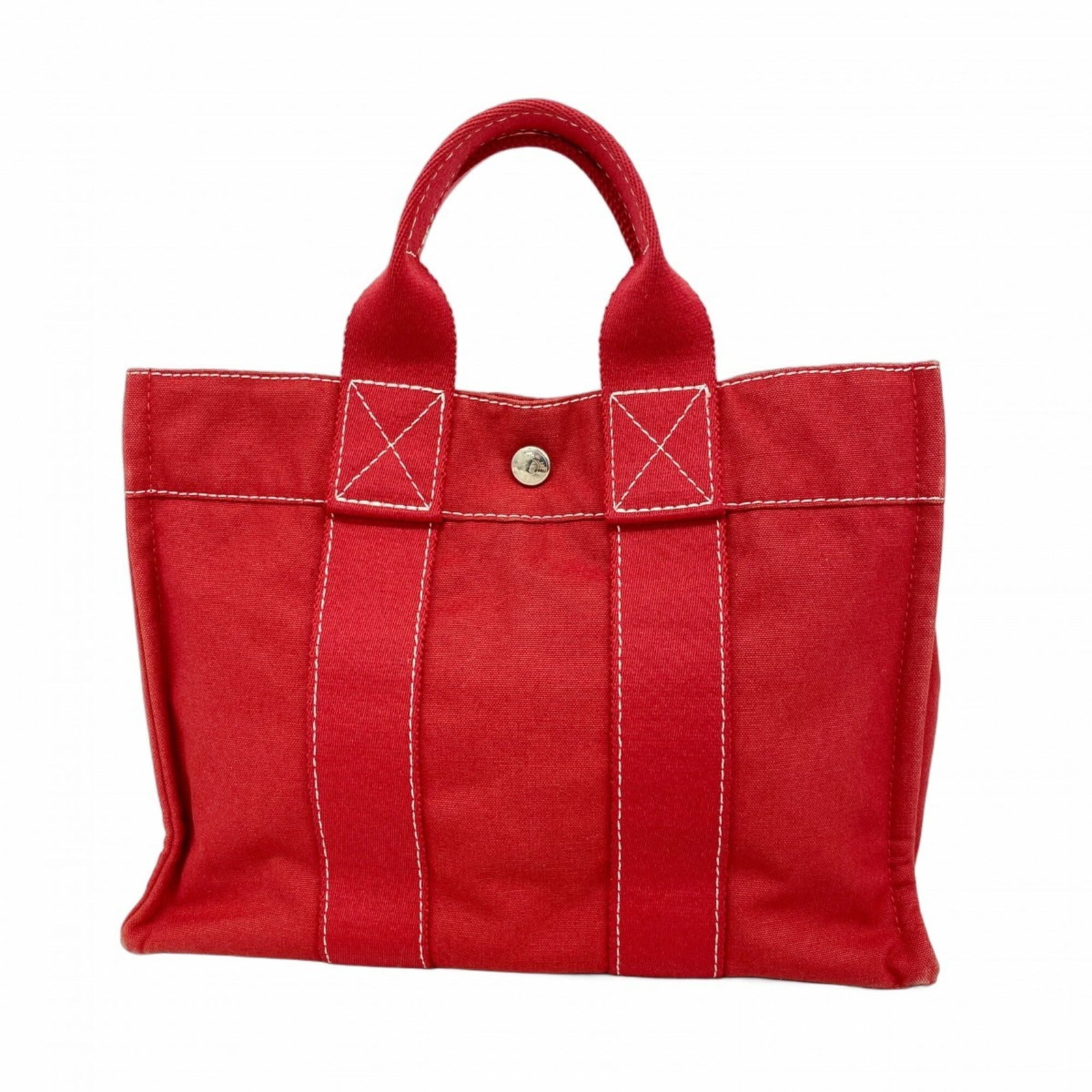Handbag from Hermes: Handbag from Hermes Red canvas handbag from Hermes, featuring silver hardware and a classic design. The bag has undergone normal wear and tear, with traces of usage visible in the form of scratches