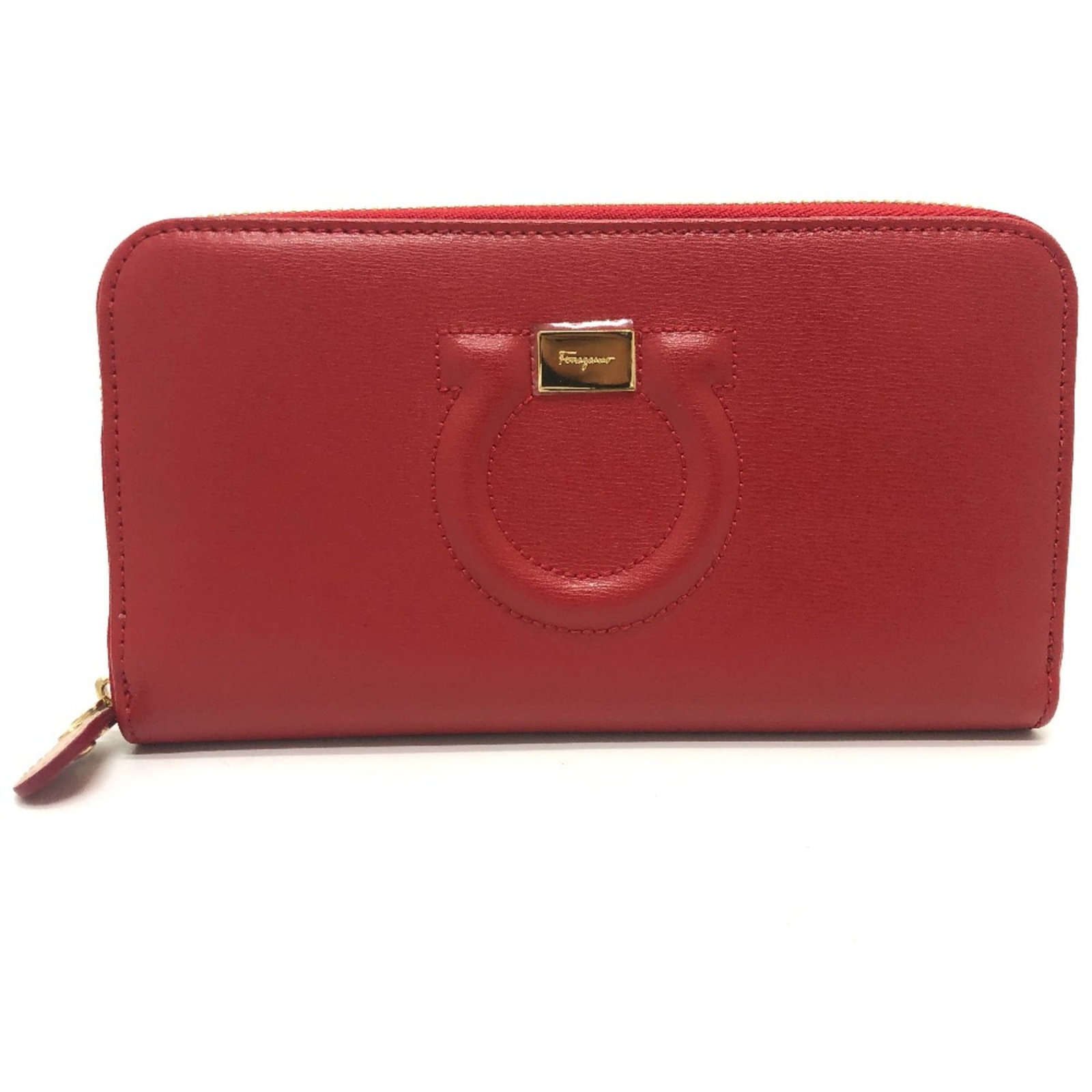 Wallet Long Bi Fold Leather Ferragamo Salvatore: Wallet Long Bi Fold Leather Ferragamo Salvatore Red leather long bi-fold wallet from Salvatore Ferragamo, featuring a classic design with a few traces of usage and some minor scratches. The condition