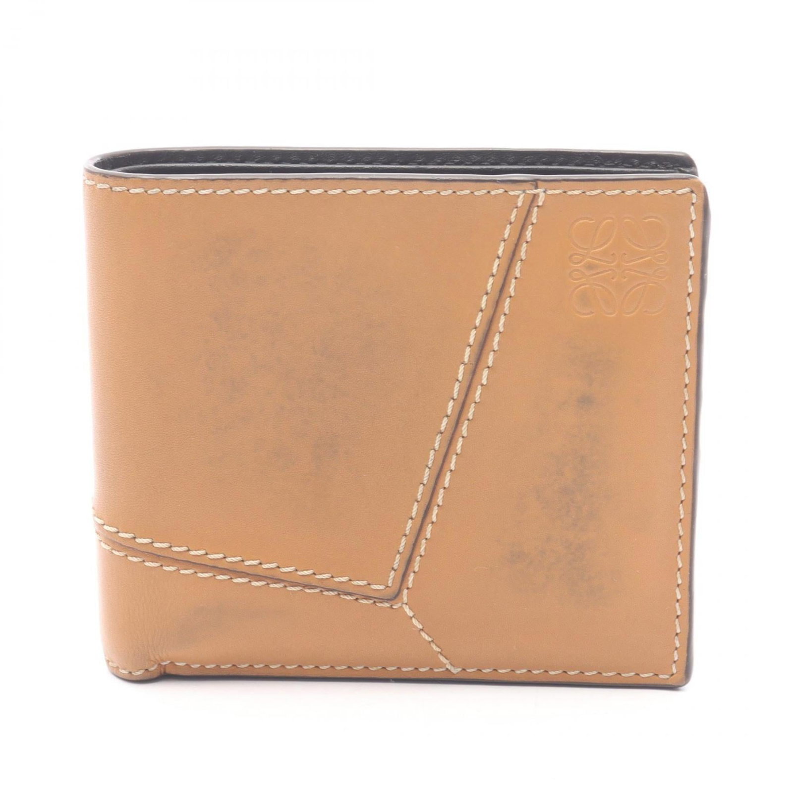 Loewe Wallet (Bi-Fold) Leather: Loewe Wallet (Bi-Fold) Leather Used Loewe Bi-Fold Leather Wallet in Brown. This bi-fold wallet features high-quality leather construction and measures 9.5cm x 11cm x 2cm. With traces of usage