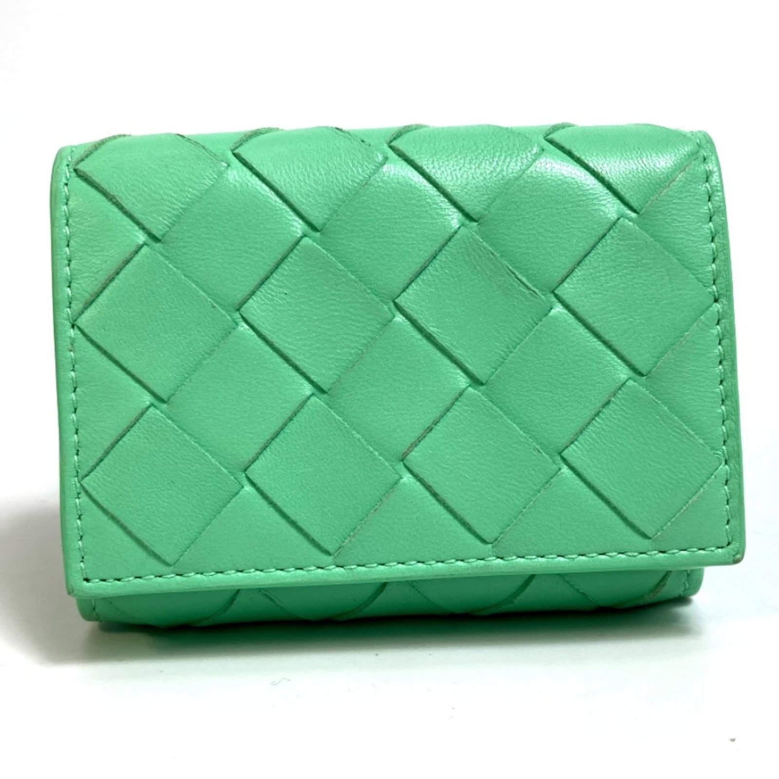 Bottega Veneta Wallet (Tri-Fold) Leather: Bottega Veneta Wallet (Tri-Fold) Leather Bottega Veneta's iconic tri-fold wallet features a rich green leather exterior, showcasing the brand's signature interlocking 'N' motif. With its classic desig