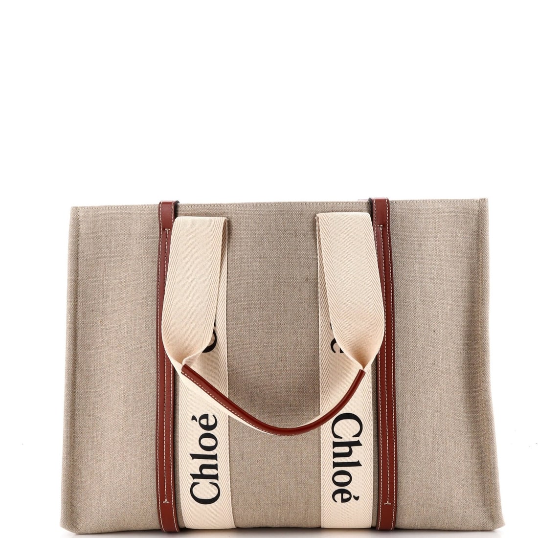 Canvas tote large leather with Chloe Woody: Canvas tote large leather with Chloe Woody Brown canvas tote with large leather straps, featuring the Chloe Woody design. This large tote measures 12.5" high and 17" wide, making it a spacious option 