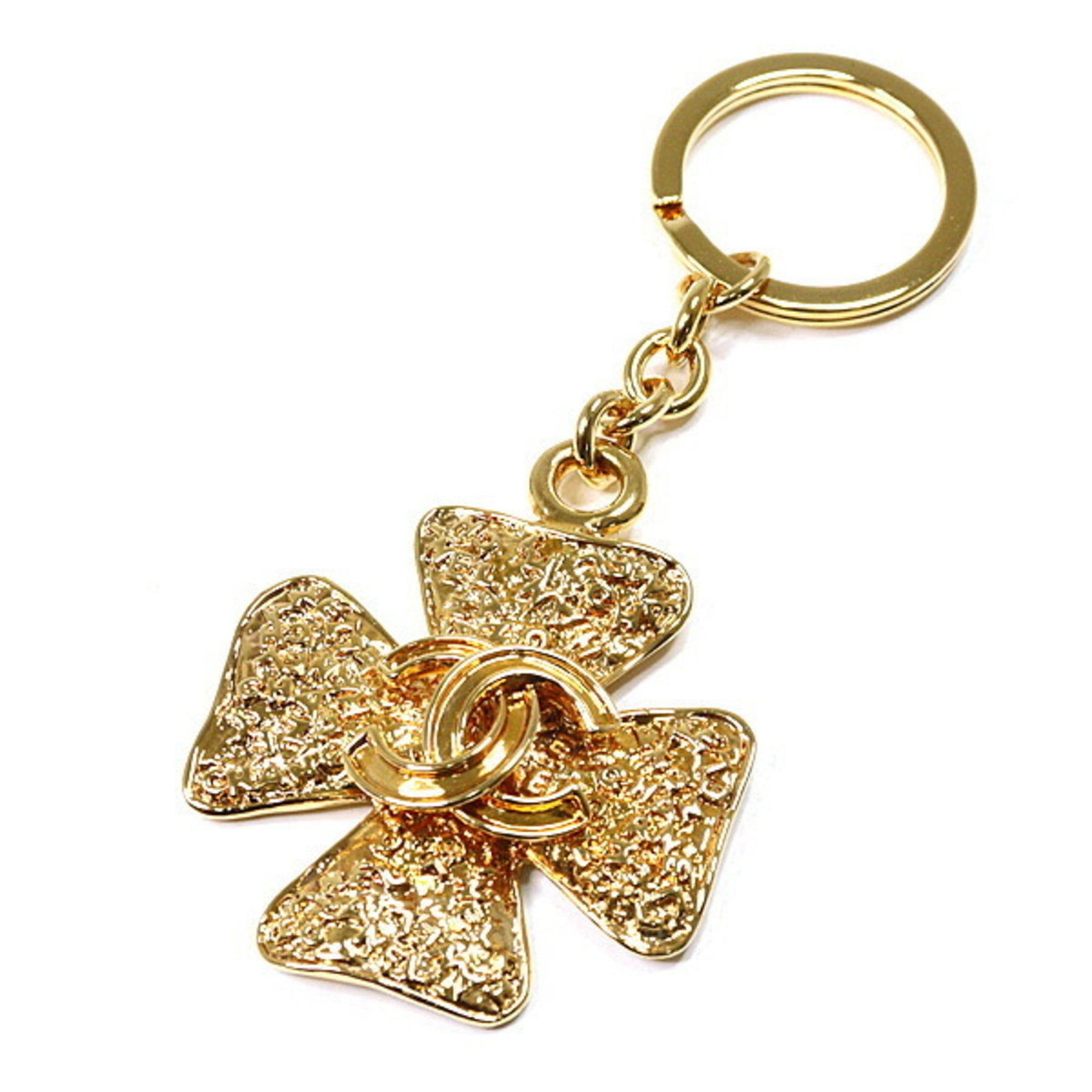 Metal Chanel Keyring: Metal Chanel Keyring This gold metal Chanel keyring boasts the iconic brand's signature style, measuring 12cm x 5cm in size. With its metal construction and subtle scratches from previous use, it show