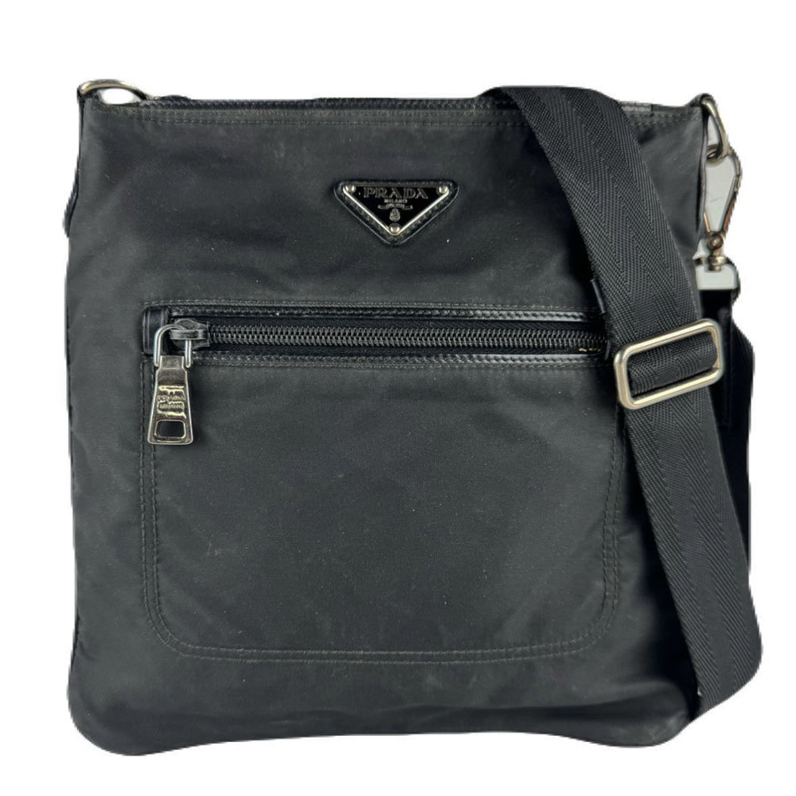 Shoulder Bag Nylon by Prada: Shoulder Bag Nylon by Prada Prada's Nylon shoulder bag boasts a sleek black design, crafted from durable nylon material. Measuring 25cm x 23cm x 1cm, it features a compact size perfect for everyday
