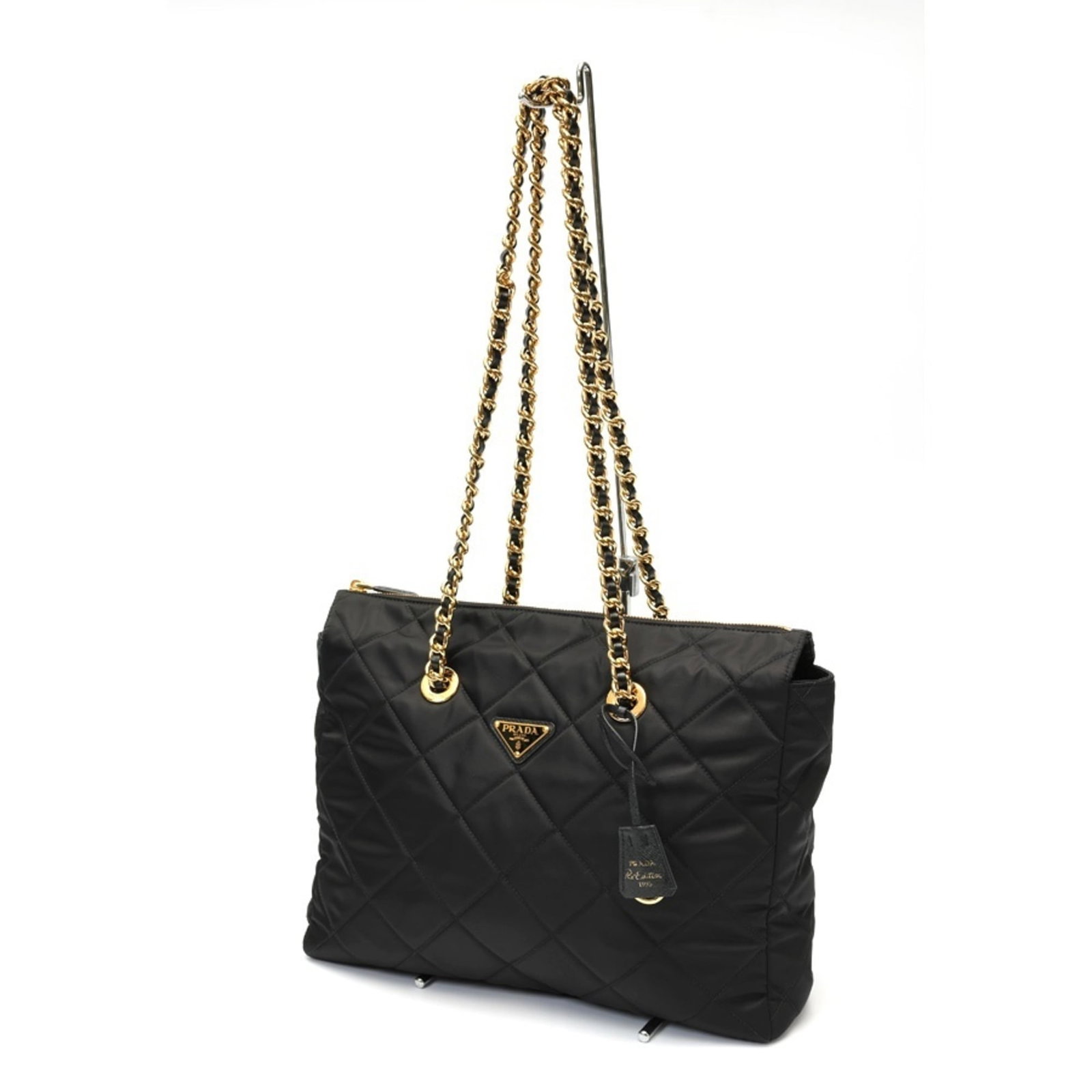 Nylon shoulder bag tote by Prada: Nylon shoulder bag tote by Prada Prada's nylon shoulder bag tote boasts sleek, sophisticated design with clean lines and minimal ornamentation. Made from durable nylon material, it features a classic 