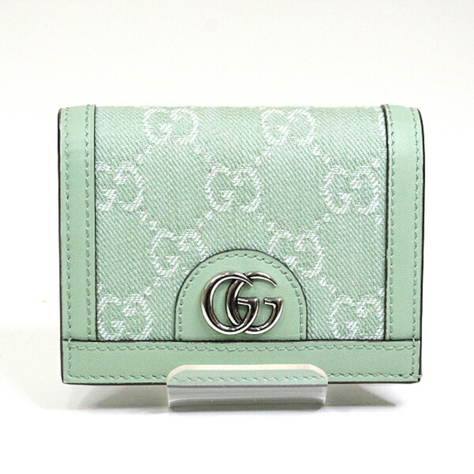 Denim Bi Fold Leather Wallet Gucci: Denim Bi Fold Leather Wallet Gucci Gucci's Denim Bi Fold Leather Wallet boasts a unique pale green hue, adding a touch of elegance to any outfit. Made from high-quality denim and leather, this bi-fold