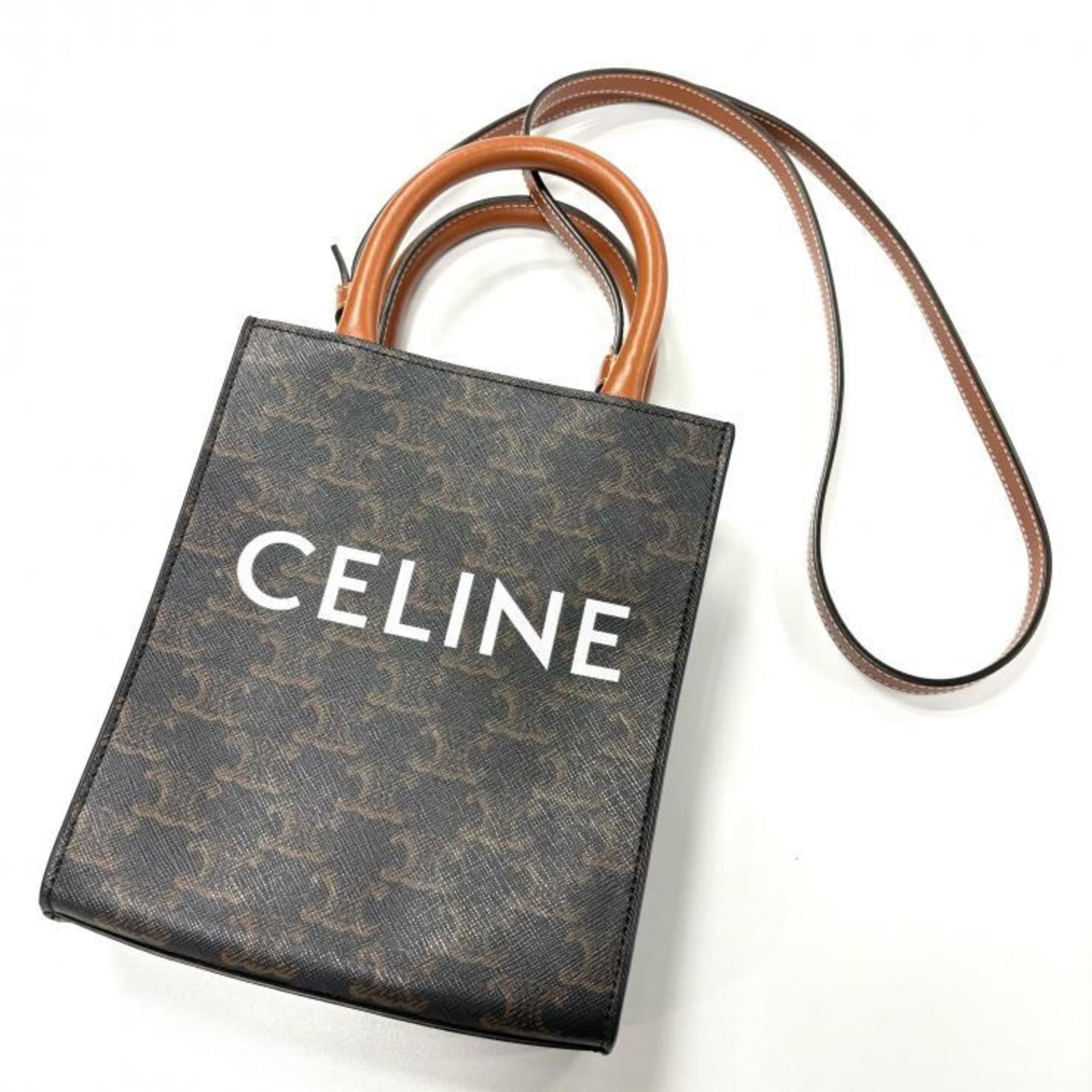 PVC Leather Celine Shoulder Bag: PVC Leather Celine Shoulder Bag PVC Leather Celine Shoulder Bag in Brown. This used shoulder bag features PVC and leather materials, with a brown color and 105cm strap length. It has traces of usage