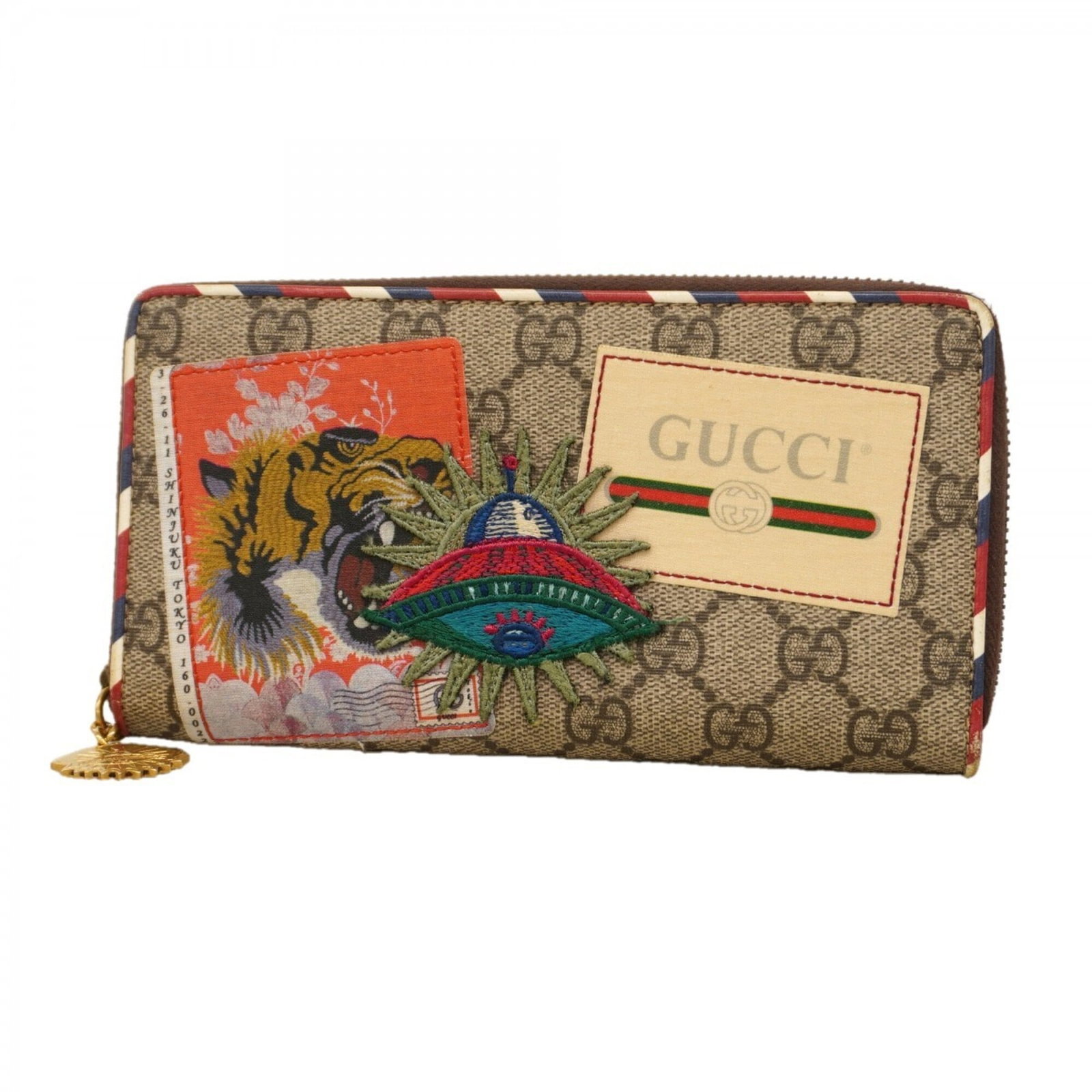 PVC Bi Fold Wallet By Gucci: PVC Bi Fold Wallet By Gucci Gucci's PVC bi-fold wallet features a sleek, brown design with a classic long wallet shape. The durable PVC material provides a stylish and practical accessory for