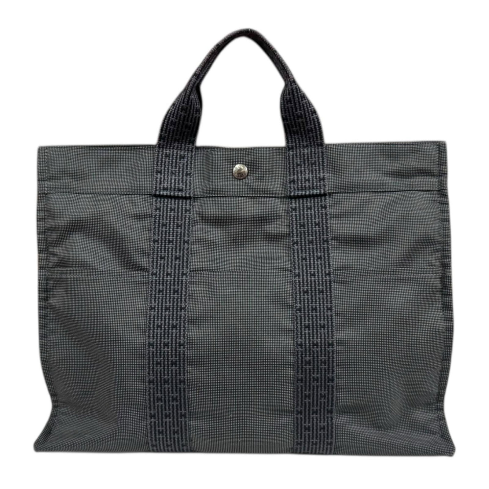 Canvas tote bag by Hermes: Canvas tote bag by Hermes Canvas tote bag by Hermes, featuring a timeless gray color and classic design. Made from high-quality canvas material, this versatile tote measures 32cm x 42cm x 10cm, with a