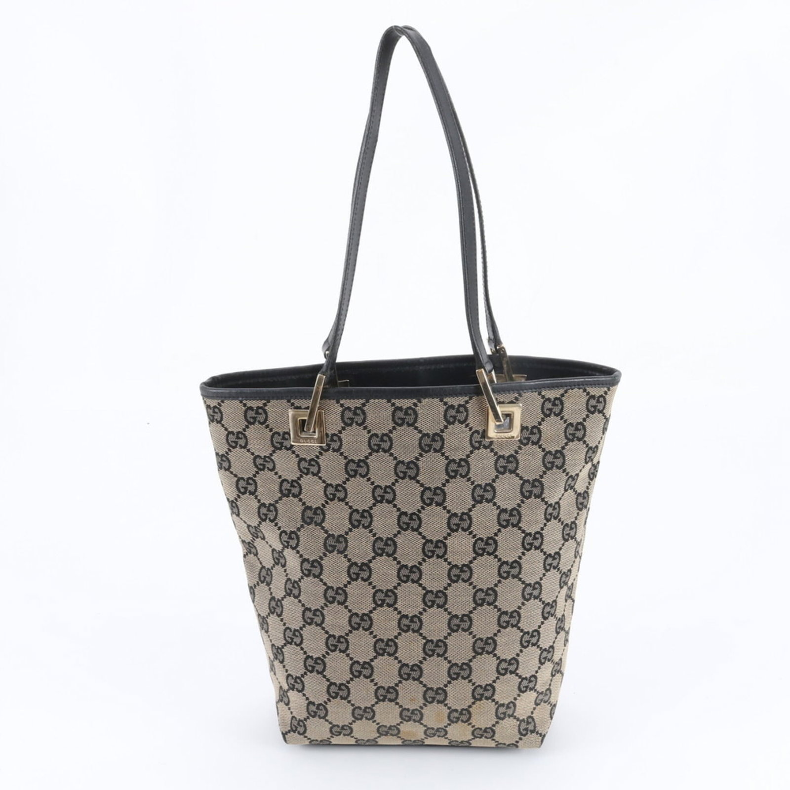 Canvas leather tote bag by Gucci: Canvas leather tote bag by Gucci Canvas leather tote bag by Gucci, featuring a classic design with a canvas and leather construction. Traces of usage are visible, including scratches and dirt, but the