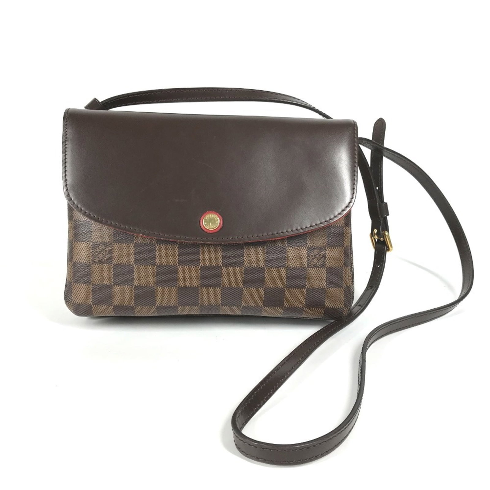 Canvas Damier Pochette Bag Vuitton Louis: Canvas Damier Pochette Bag Vuitton Louis Brown, Ebene Damier Canvas Pochette Bag from Louis Vuitton features a classic design with a mix of earthy tones. The bag's condition shows some signs of