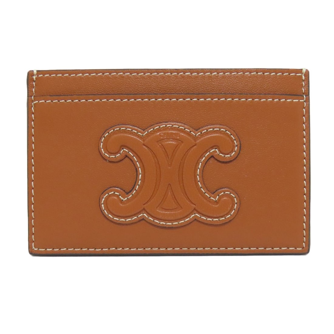 Leather Card Celine Triomphe: Leather Card Celine Triomphe Brown leather card case from CELINE, featuring the iconic Celine Triomphe design. This classic style showcases rich brown leather that adds a touch of sophistication to an
