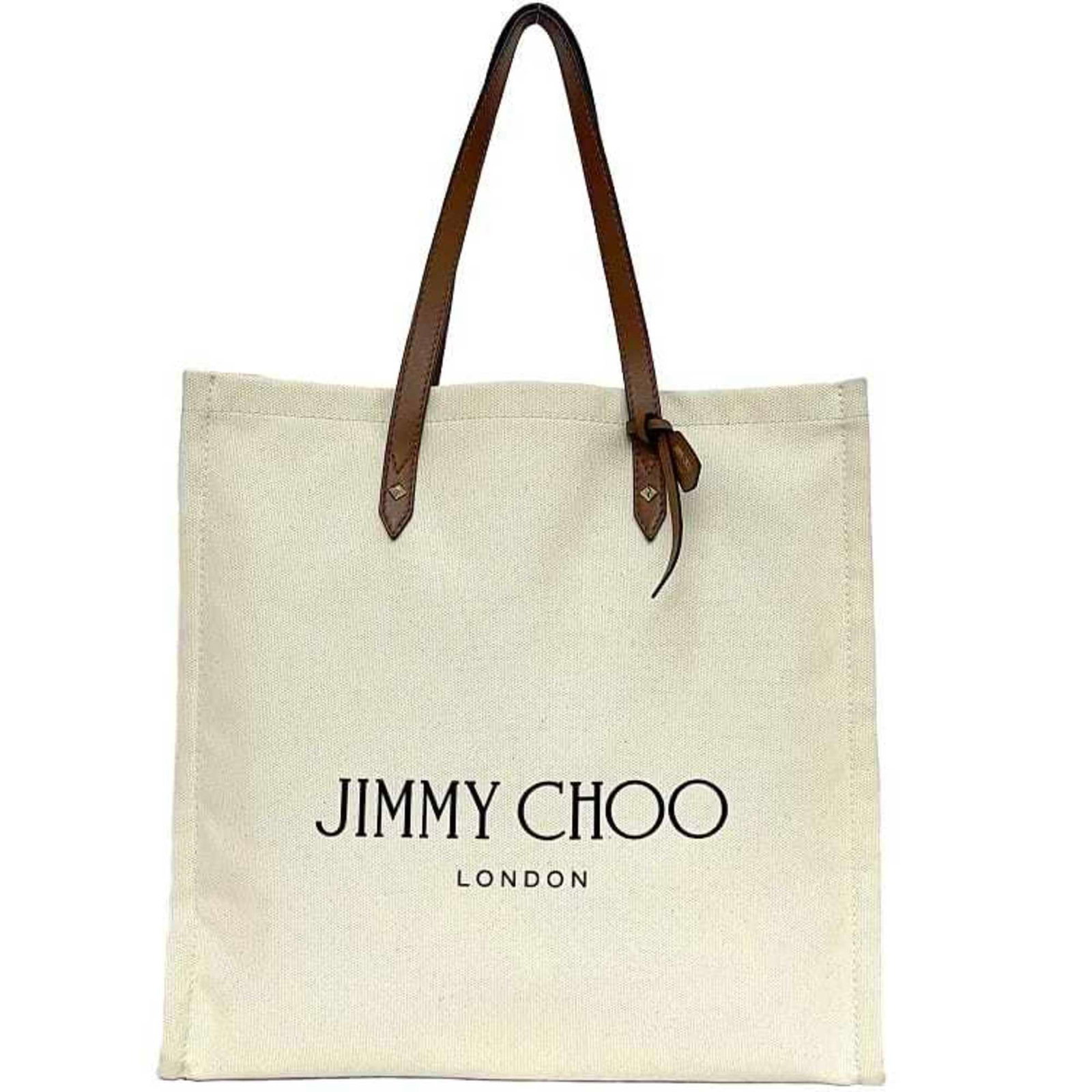 Jimmy Choo tote bag canvas leather: Jimmy Choo tote bag canvas leather Brown and white canvas leather tote bag from Jimmy Choo, featuring a classic design with a few traces of usage visible. The bag has some scratches and dirt but