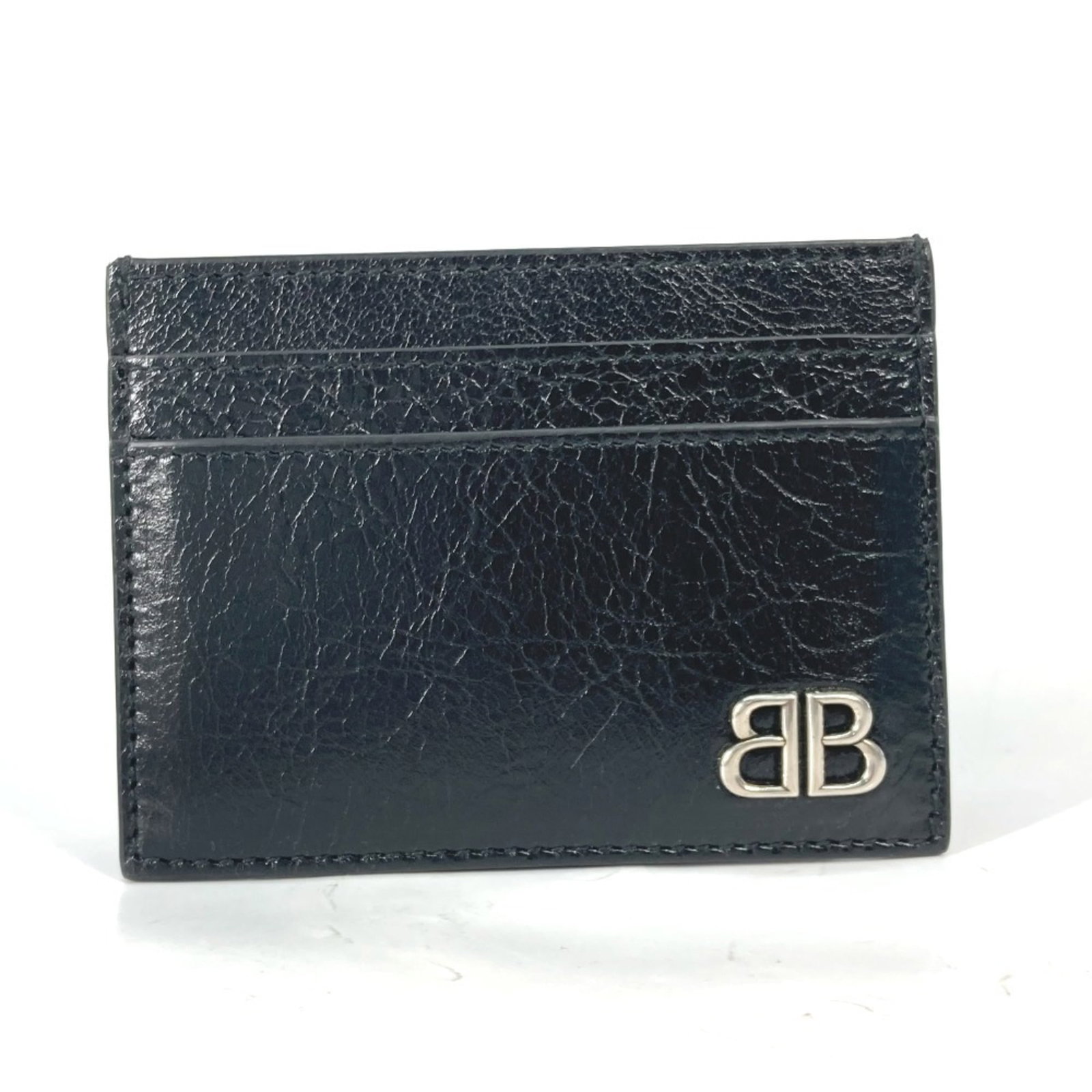 Card case in leather by Balenciaga: Card case in leather by Balenciaga Black leather card case by Balenciaga, made from high-quality material. This opened card case bears the signature of the brand, showcasing its attention to detail