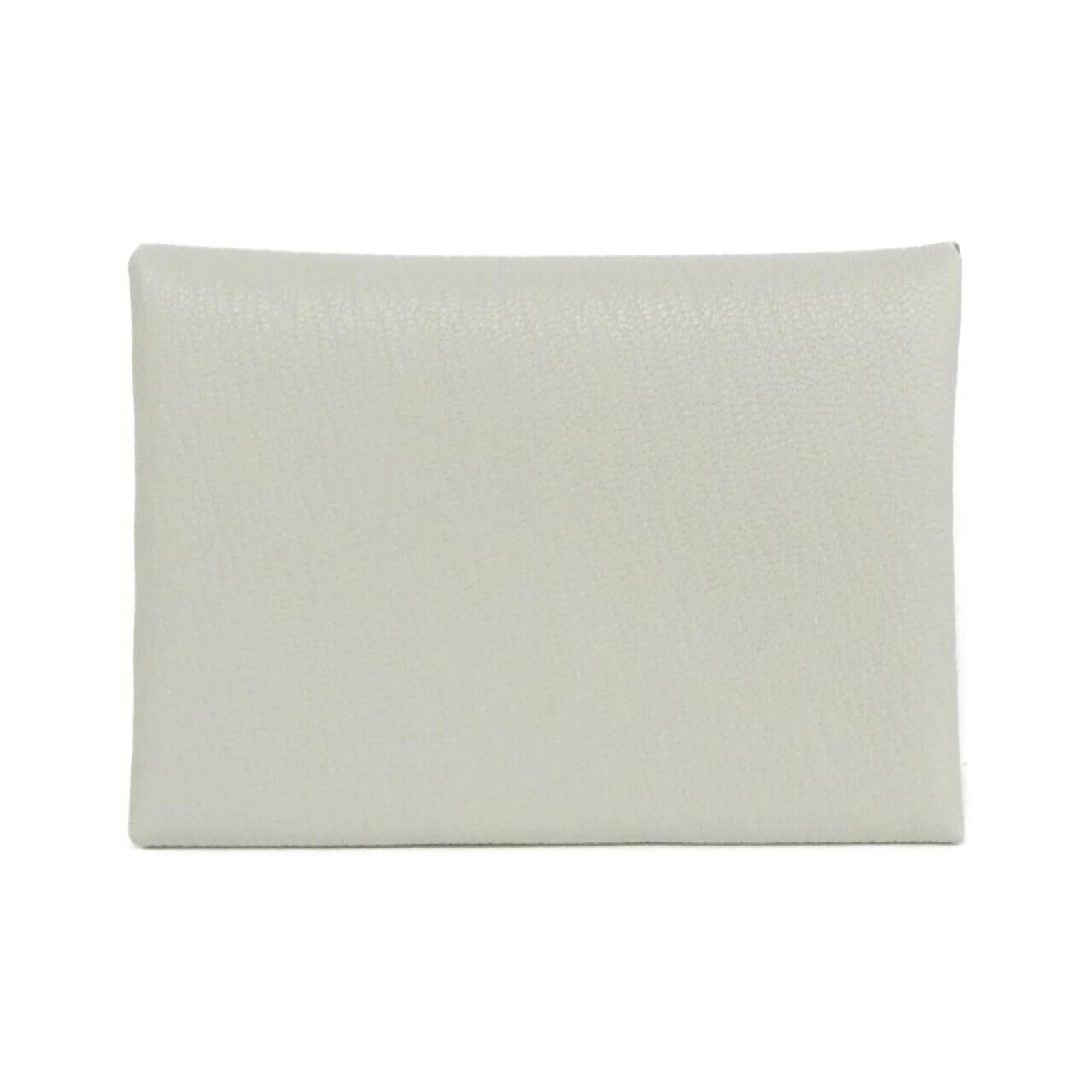 Hermes Coin Purse/ Coin Case Chevre Leather: Hermes Coin Purse/ Coin Case Chevre Leather Chevre leather coin purse in beige, featuring a classic design with clean lines and minimal embellishments. The used condition shows some minor scratches