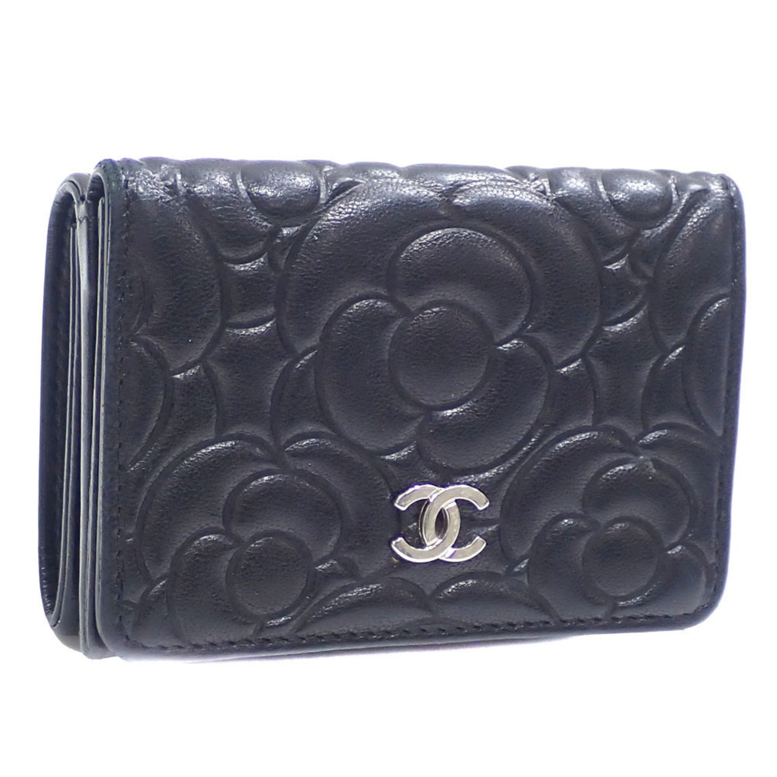 Leather Tri-Fold Wallet By Chanel: Leather Tri-Fold Wallet By Chanel Black lambskin leather tri-fold wallet from Chanel, featuring a classic design with three folds for organization. The item has been used and shows traces of usage,