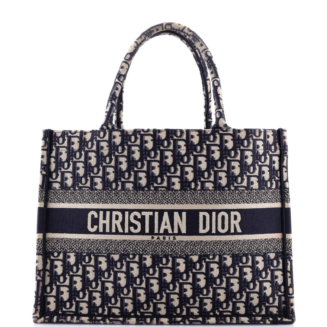 Christian Dior Oblique Canvas Tote Book Medium: Christian Dior Oblique Canvas Tote Book Medium The Christian Dior Oblique Canvas Tote Book Medium boasts a striking blue canvas exterior with subtle scuffs and corner wear, giving it a worn-in look.
