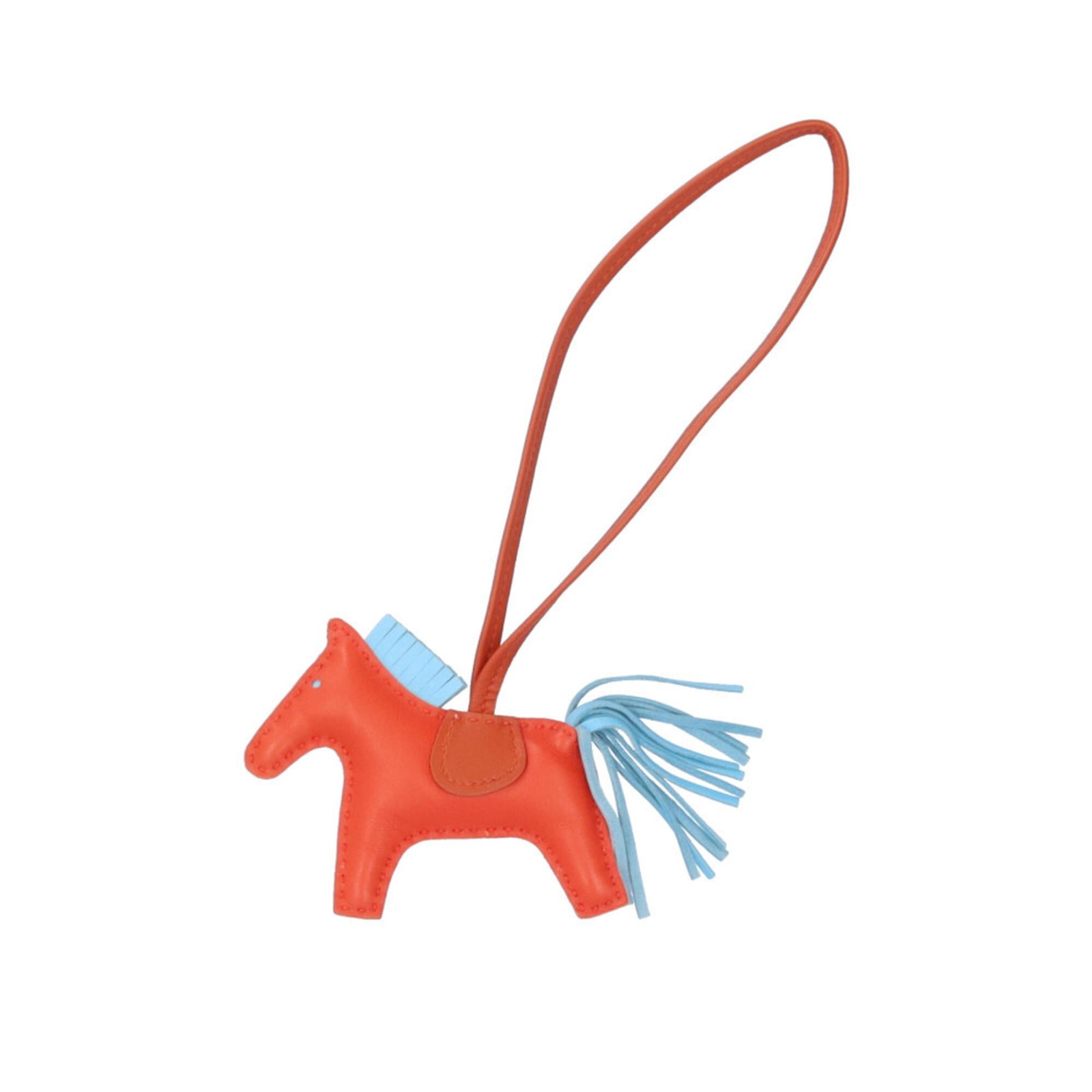 Agneau Keyring Hermes Milo: Agneau Keyring Hermes Milo Agneau Milo keyring from Hermes features an orange hue and chain/strap length of 23cm. The item has traces of usage, scratches, and dirt, but remains in good condition. Its