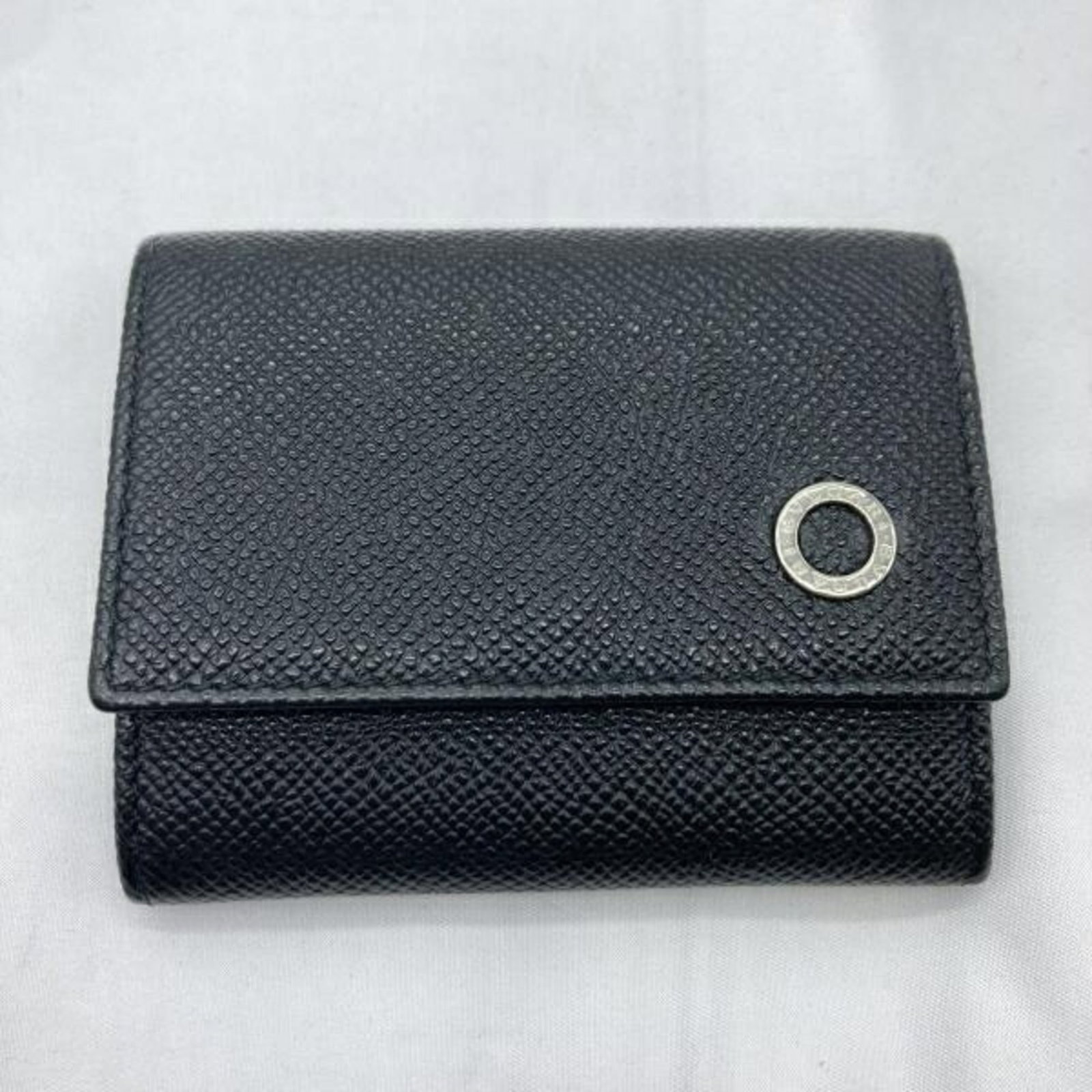 Bvlgari Coin Purse/ Coin Case: Bvlgari Coin Purse/ Coin Case Black Bvlgari Coin Purse with a few traces of usage and some scratches/dirt, still in very good condition. Measuring 8cm x 9.5cm, it offers a compact storage solution for