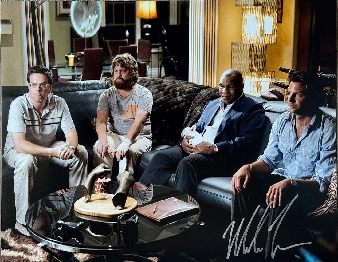 Mike Tyson Autographed Hangover 16x20 Photo: Mike Tyson Autographed Hangover 16x20 Photo Mike Tyson's bold signature in silver sharpie adds a touch of rebellious charm to this 16x20 photo, capturing the essence of his larger-than-life persona.