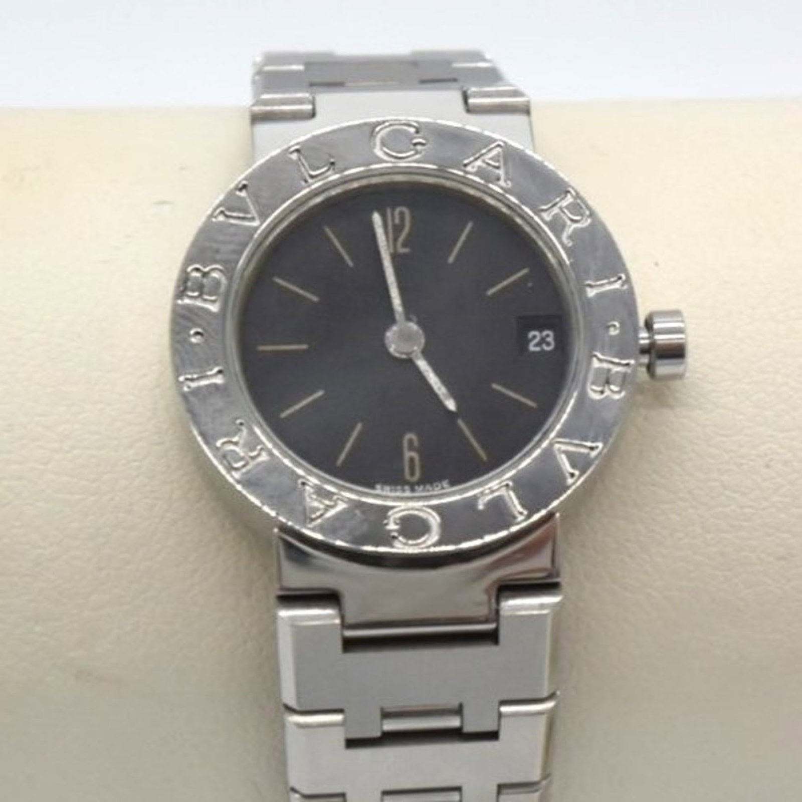 Bvlgari Wristwatch: Bvlgari Wristwatch Stainless steel case and band add an edgy touch to this Bvlgari women's wristwatch, featuring an analog display in a sleek black dial. The watch measures 23mm in diameter with a