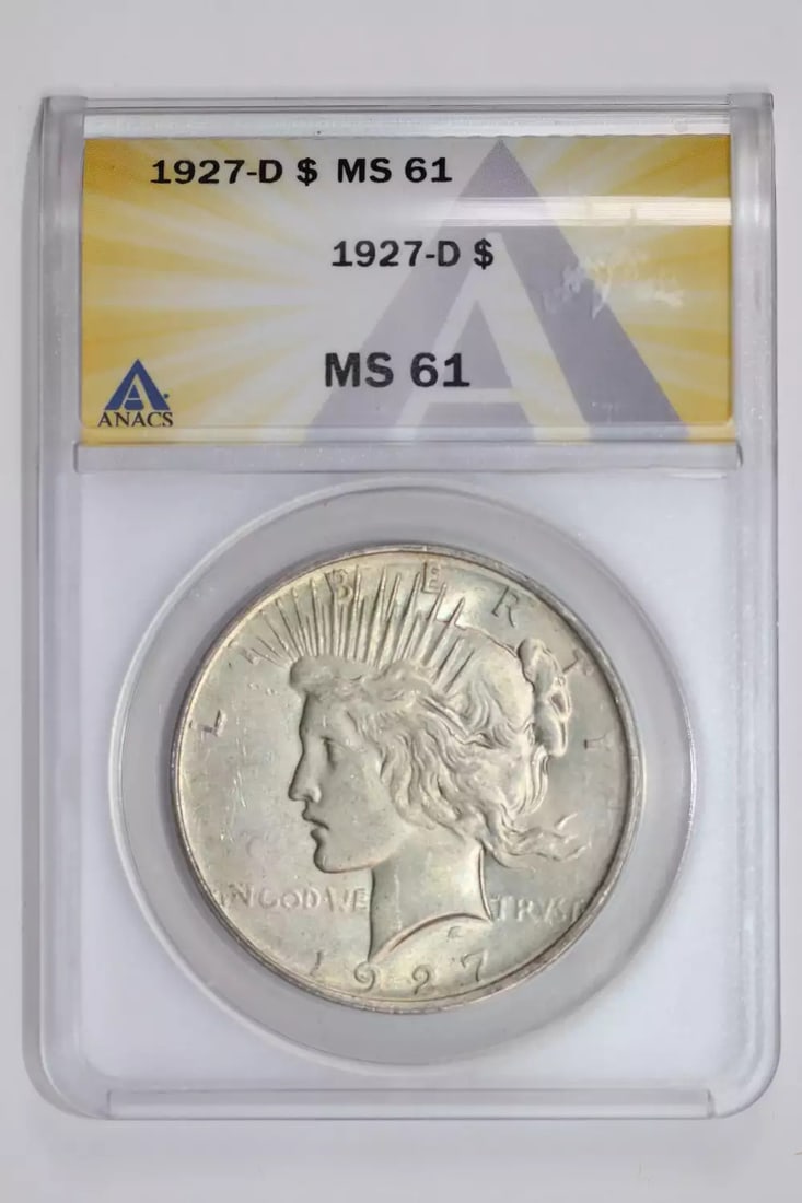 1927-D PEACE DOLLAR ANACS MS61: 1927-D PEACE DOLLAR ANACS MS61 The 1927-D Peace Dollar, graded MS61 by ANACS, showcases its exceptional condition with a high level of detail and luster. This uncirculated coin from the Denver mint
