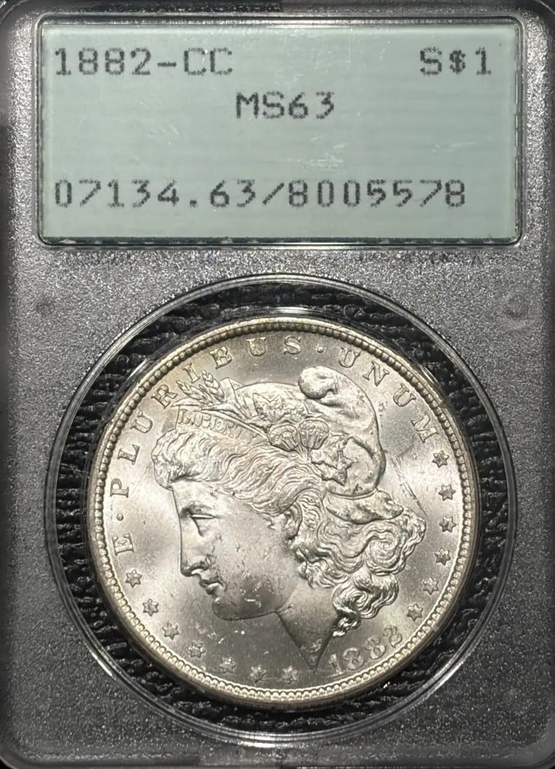 1882-CC MORGAN DOLLAR PCGS MS63 RATTLER OGH: 1882-CC MORGAN DOLLAR PCGS MS63 RATTLER OGH The 1882-CC Morgan Dollar, graded MS63 by PCGS, boasts a rich history as part of the Carson City mint's production. This uncirculated coin features the