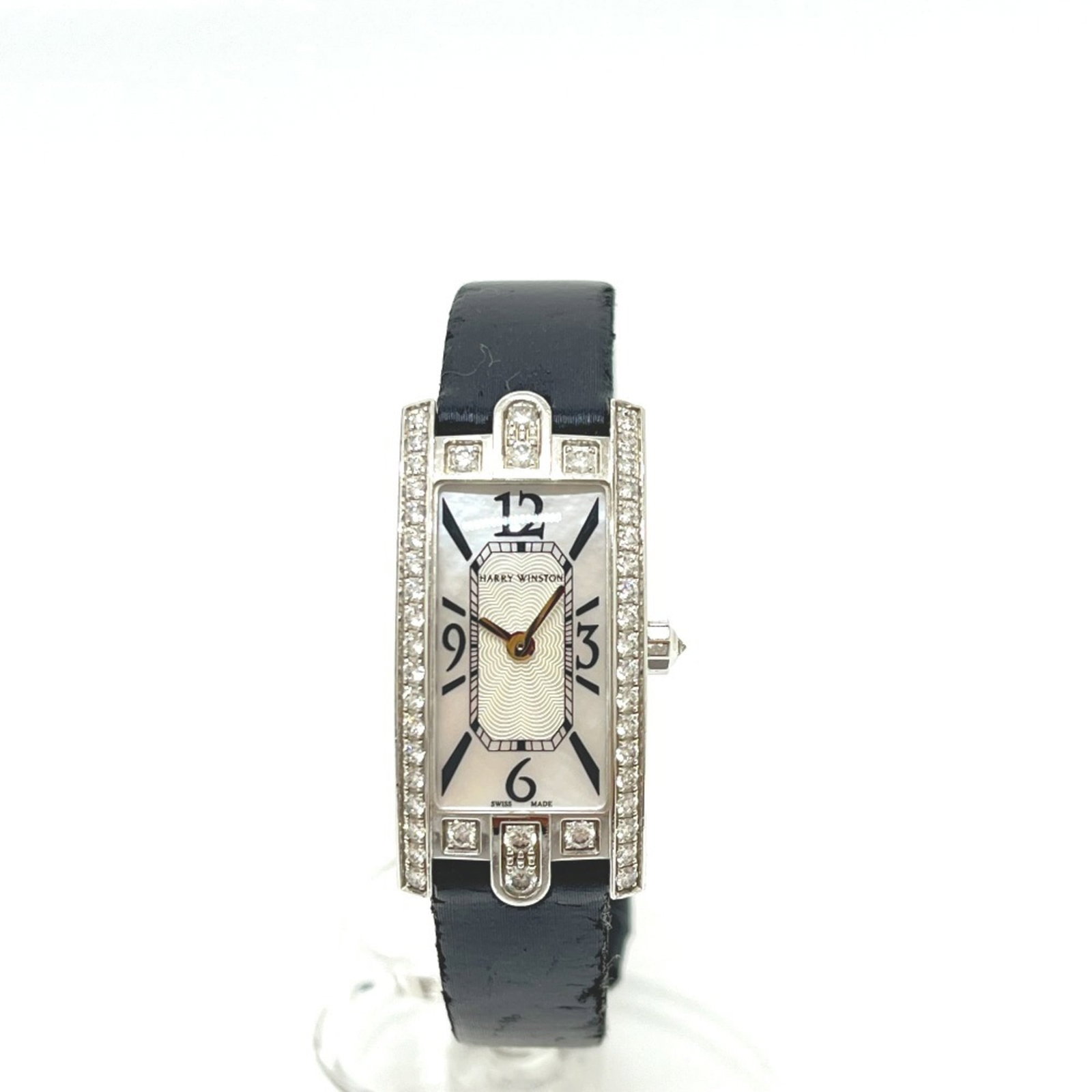 Harry Winston Wristwatch: Harry Winston Wristwatch White gold (18K) wristwatch with a 15mm case diameter, suitable for wrists up to 16cm in size. The watch features a white dial and bears a signature. Traces of usage are