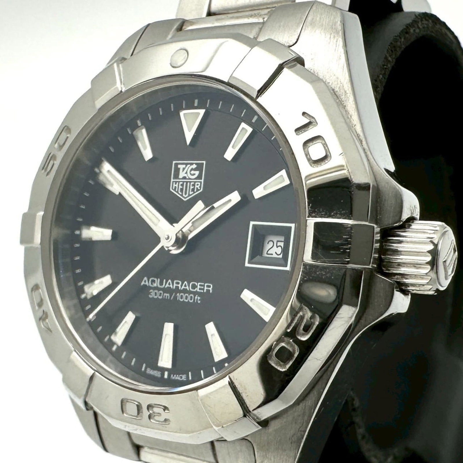 Tag Heuer Wristwatch: Tag Heuer Wristwatch Stainless steel case and band provide a sleek, modern look for women. The black dial stands out against the subtle shine of the metal, creating a sophisticated timepiece. With