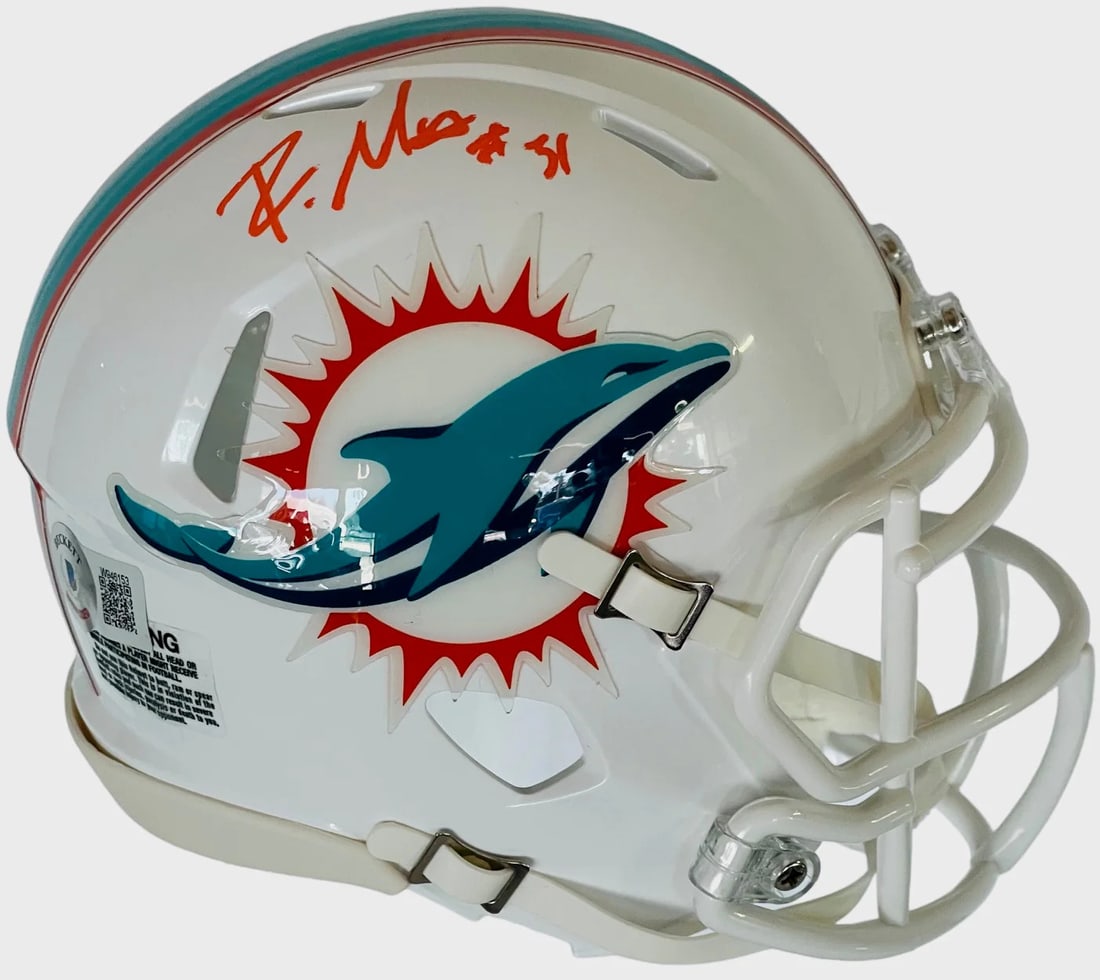 Mostert Autographed Beckett Mini Helmet: Mostert Autographed Beckett Mini Helmet Signed in orange paint pen above the Dolphins Logo, Raheem Mostert's mini helmet bears his signature. This Beckett-graded item provides authentic verification