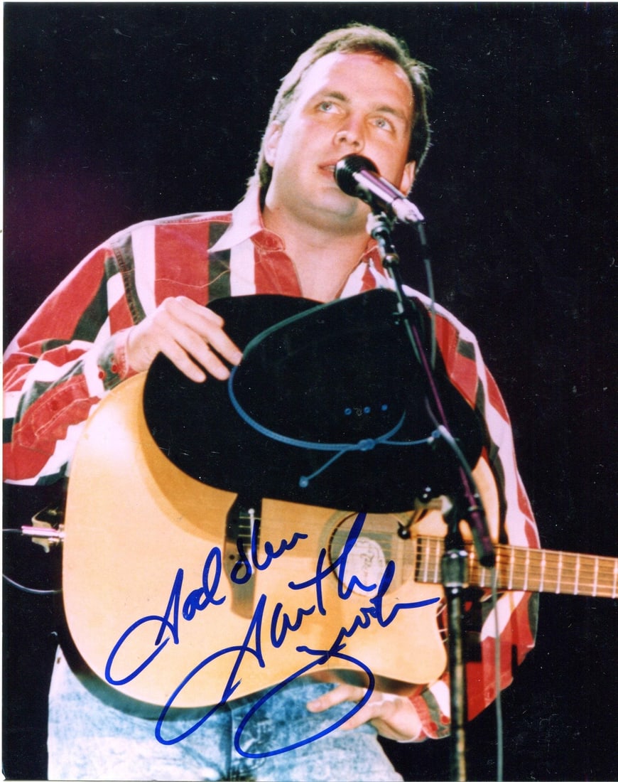 Garth Brooks 8x10 Photo Autographed: Garth Brooks 8x10 Photo Autographed 8x10 photo signed by Garth Brooks in blue sharpie, accompanied by a certificate from . This unique item bears the artist's mark, making it a notable possession for