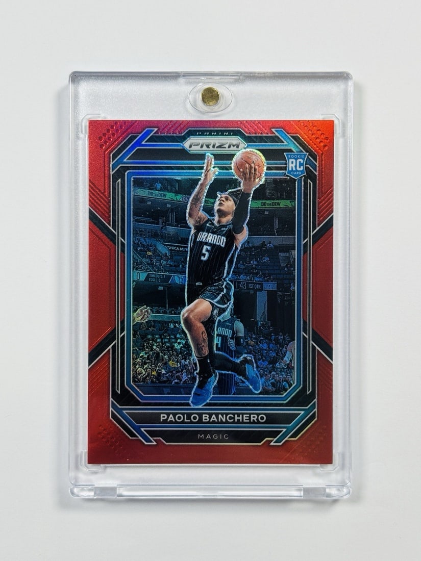 2022-23 PANINI PRIZM PAOLO BANCHERO #249 RED ROOKIE PRIZM/ 299: 2022-23 PANINI PRIZM PAOLO BANCHERO #249 RED ROOKIE PRIZM/ 299 Paolo Banchero #249 Red Rookie Prizm/299 features an autograph label on standard card stock, bearing the signature of Paolo Banchero.