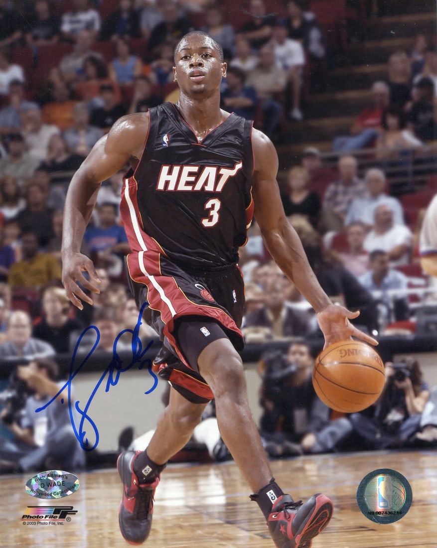 Dwyane Wade Autographed Dribbling Rookie Photo 8x10: Dwyane Wade Autographed Dribbling Rookie Photo 8x10 Dwyane Wade's impressive dribbling skills are on full display in this 8x10 photo, capturing his rookie moment. The image bears a blue sharpie