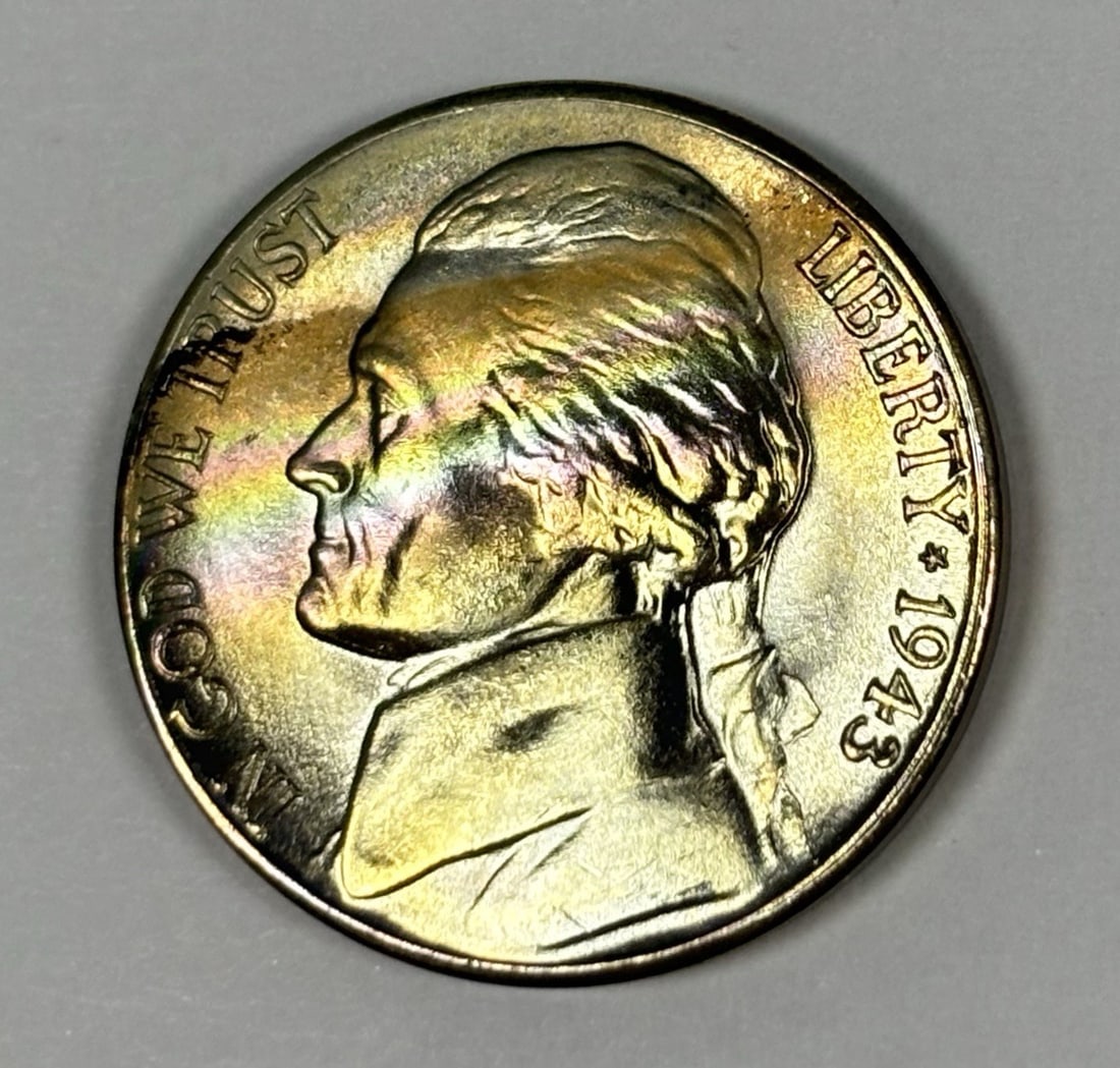 1943-S JEFFERSON WAR NICKEL UNCIRCULATED WITH PRETTY RAINBOW TONING: 1943-S JEFFERSON WAR NICKEL UNCIRCULATED WITH PRETTY RAINBOW TONING This 1943-S Jefferson nickel showcases its unique charm with striking rainbow toning, adding an extra layer of visual appeal to its 