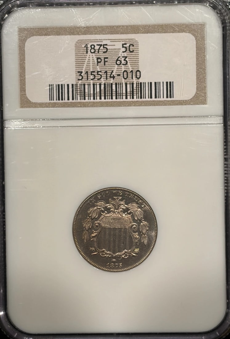 1875 PROOF SHIELD NICKEL NGC PR63: 1875 PROOF SHIELD NICKEL NGC PR63 1875 Proof Shield Nickel, graded PF 63 by the Numismatic Guaranty Corporation (NGC), showcases exceptional detail and luster. This uncirculated proof coin features a