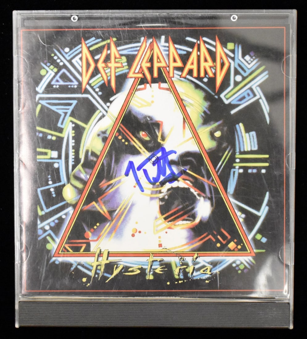 Joe Elliott Signed/ Autographed Def Leppard Hysteria CD Cover JSA BA208659: Joe Elliott Signed/ Autographed Def Leppard Hysteria CD Cover JSA BA208659 Joe Elliott's distinctive signature adorns the Def Leppard Hysteria CD cover, making this item a unique collectible for fans