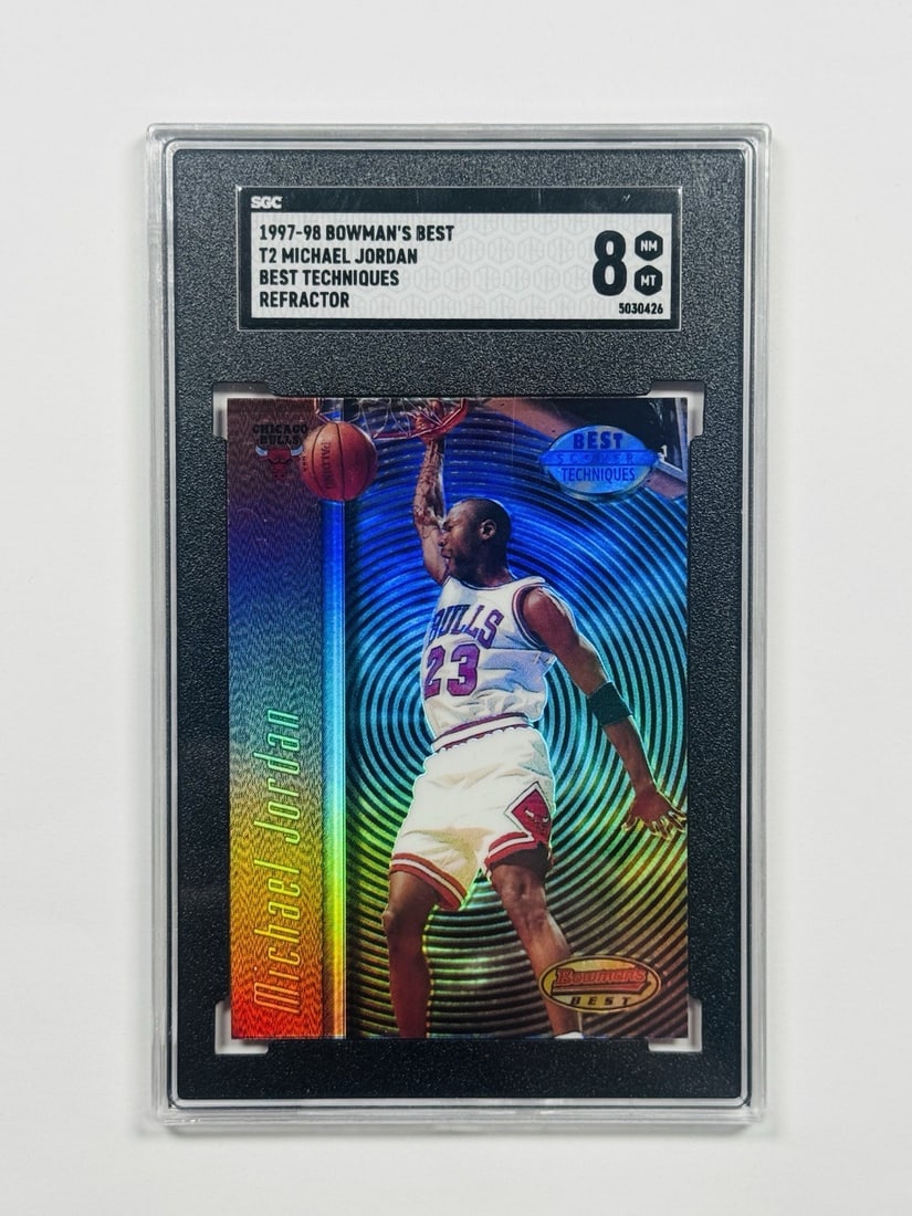 1997-98 BOWMANS BEST MICHAEL JORDAN #T2 BEST TECHNIQUES REFRACTOR SGC 8: 1997-98 BOWMANS BEST MICHAEL JORDAN #T2 BEST TECHNIQUES REFRACTOR SGC 8 This 1997-98 Bowman's Best Refractor features Michael Jordan, one of the most iconic players in NBA history. The card boasts a