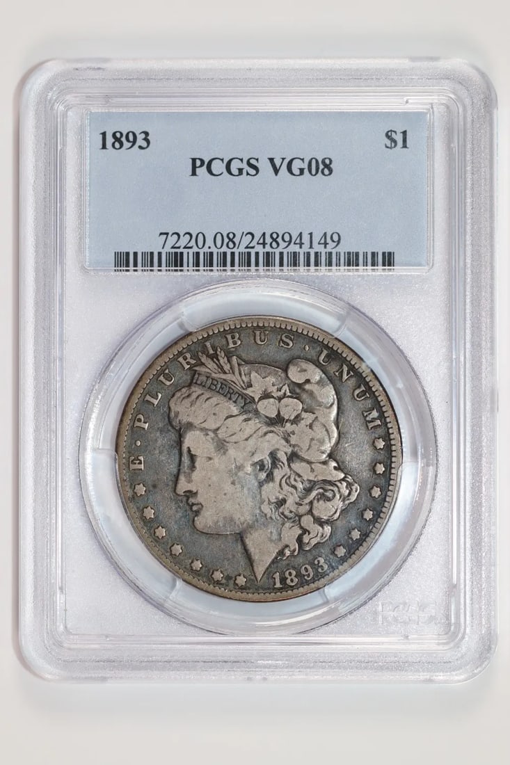 1893 MORGAN DOLLAR PCGS VG8: 1893 MORGAN DOLLAR PCGS VG8 The 1893 Morgan Dollar, graded VG 8 by PCGS, showcases its circulated condition with subtle wear and tear. Certified by the prestigious Professional Coin Grading Service