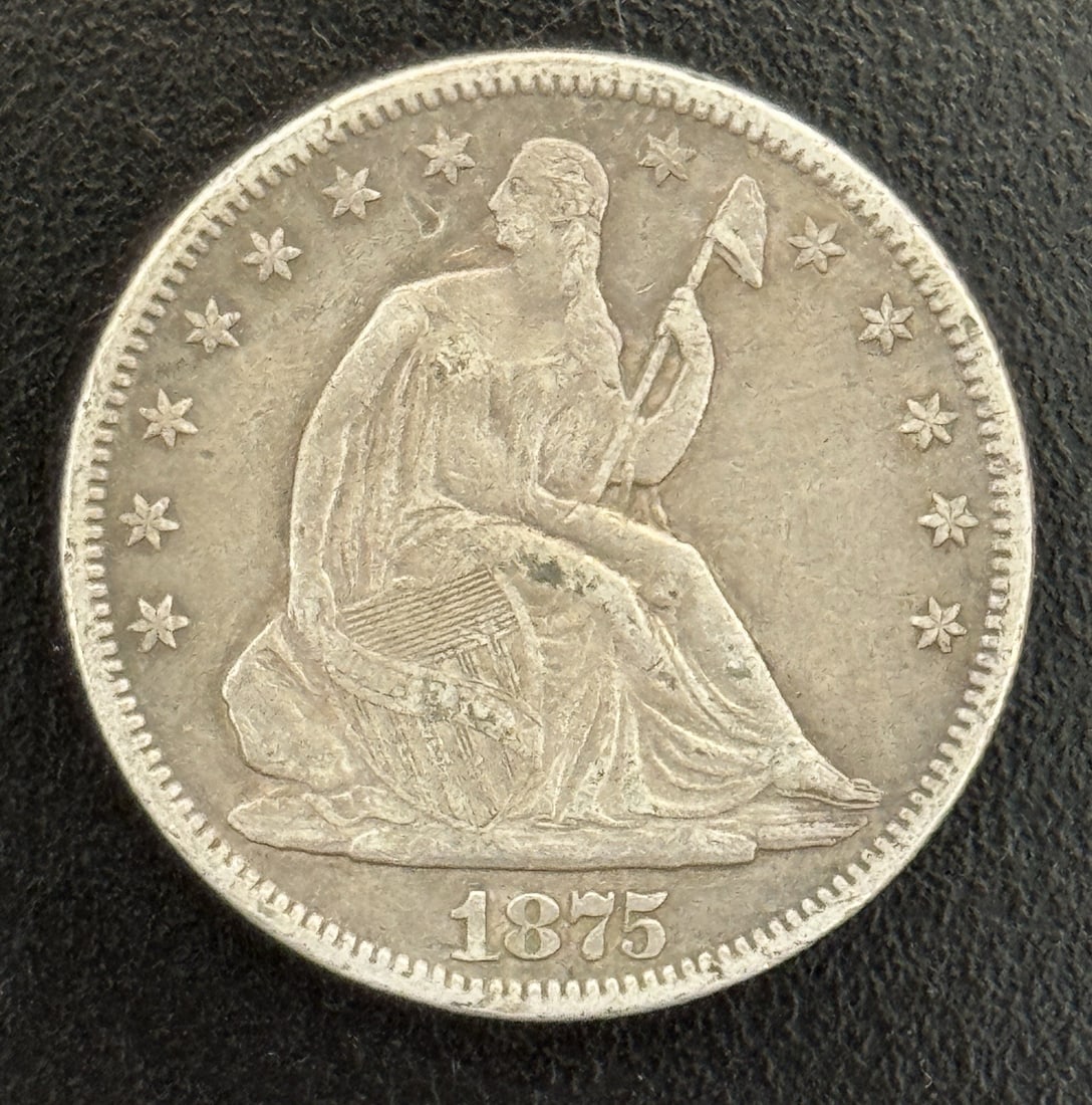 SEATED LIBERTY HALF DOLLAR XF DETAILS: SEATED LIBERTY HALF DOLLAR XF DETAILS Seated Liberty half dollar from 1875, minted in Philadelphia. This circulated coin boasts XF details, showcasing its condition with notable features that make it
